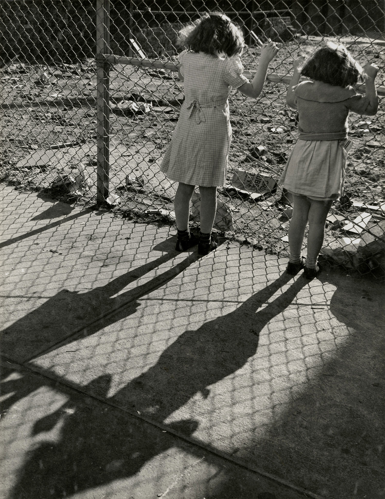 A wire fence is put up to keep trespassers out, from Playgrounds for Manhattan, 1938