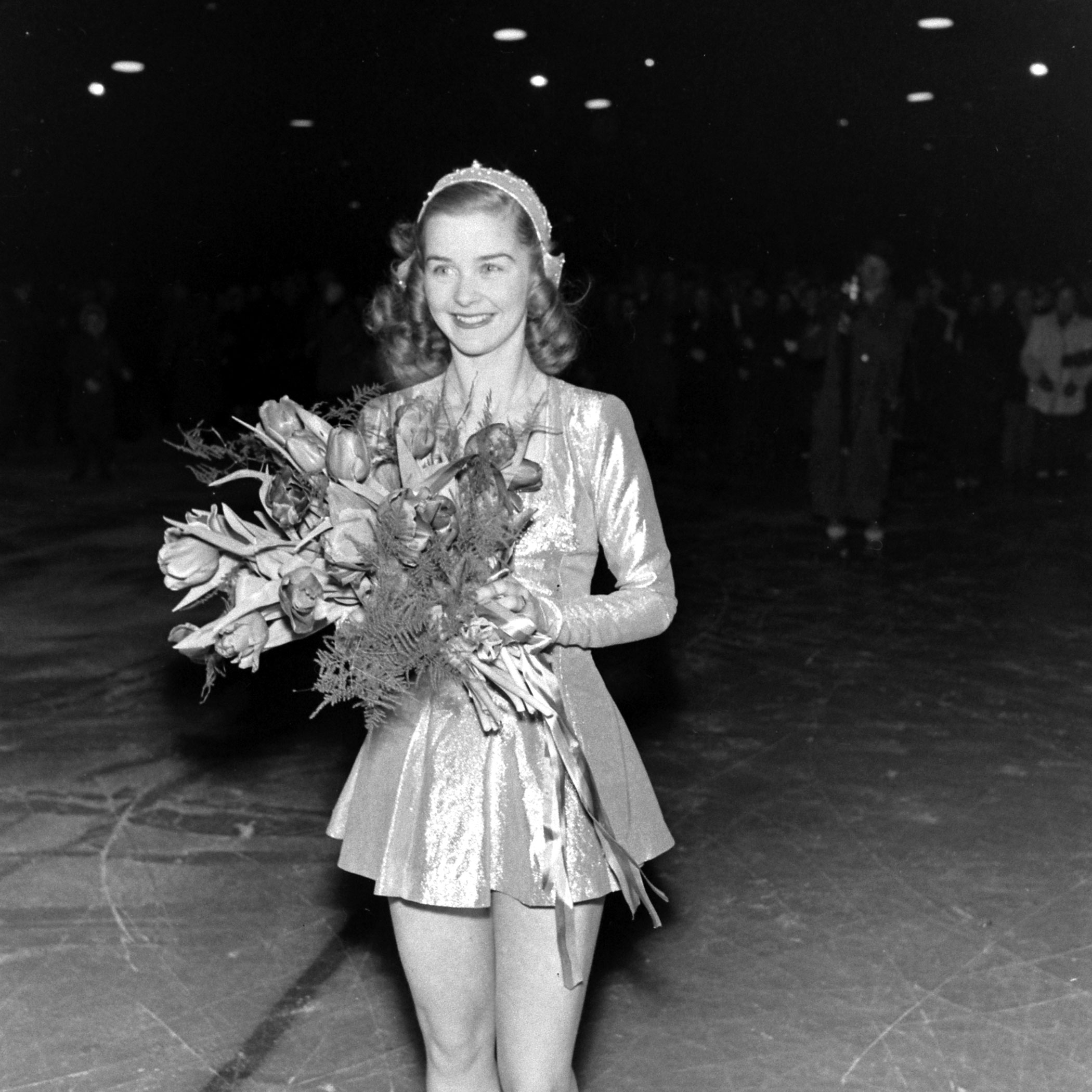 Barbara Ann Scott with flowers at the World Figure Skating Championship in Stockholm, Sweden, 1947.