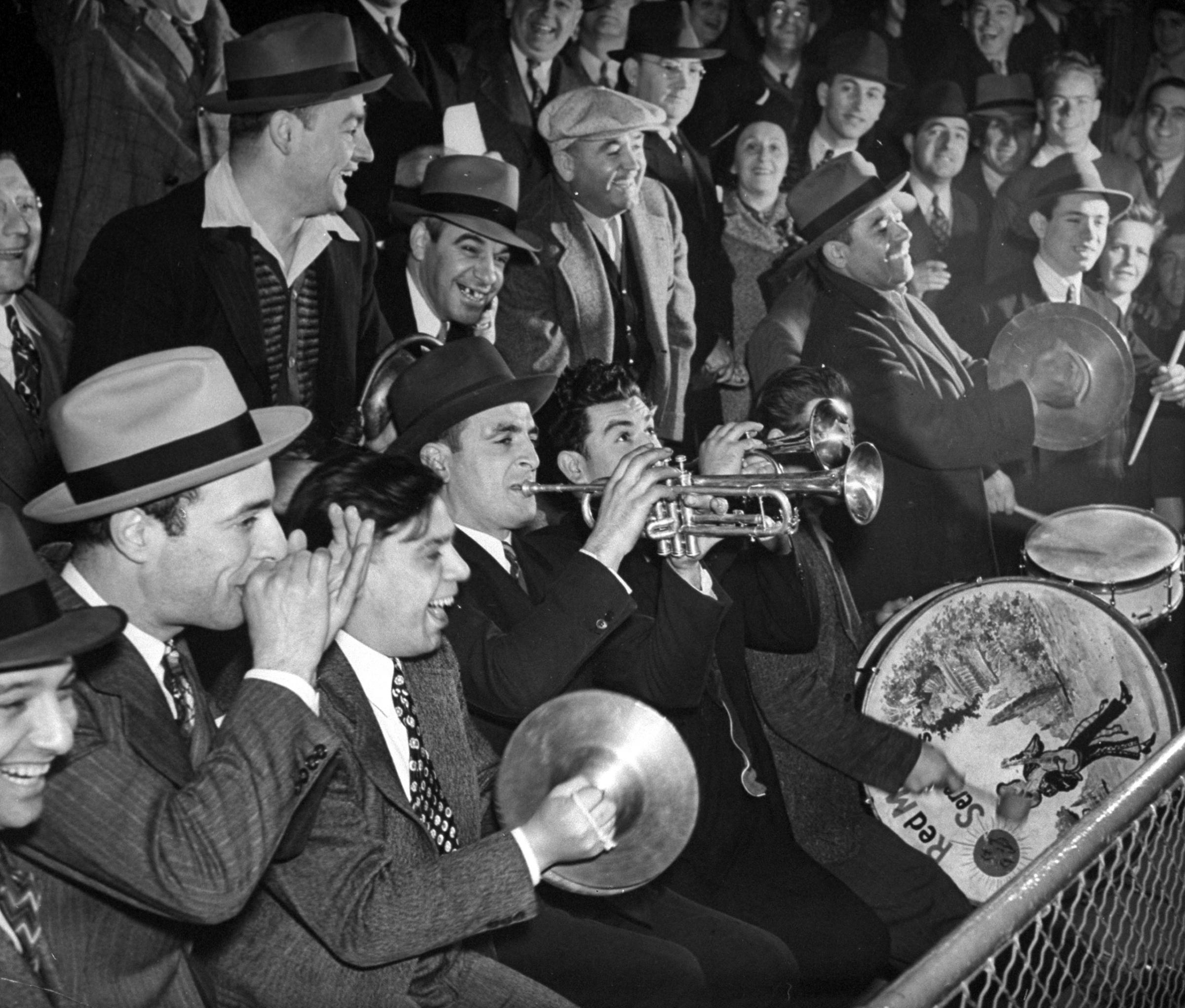 Fans playing instruments and cheering while watching a Brooklyn Dodgers baseball game at Ebbets Field, May 1940.
