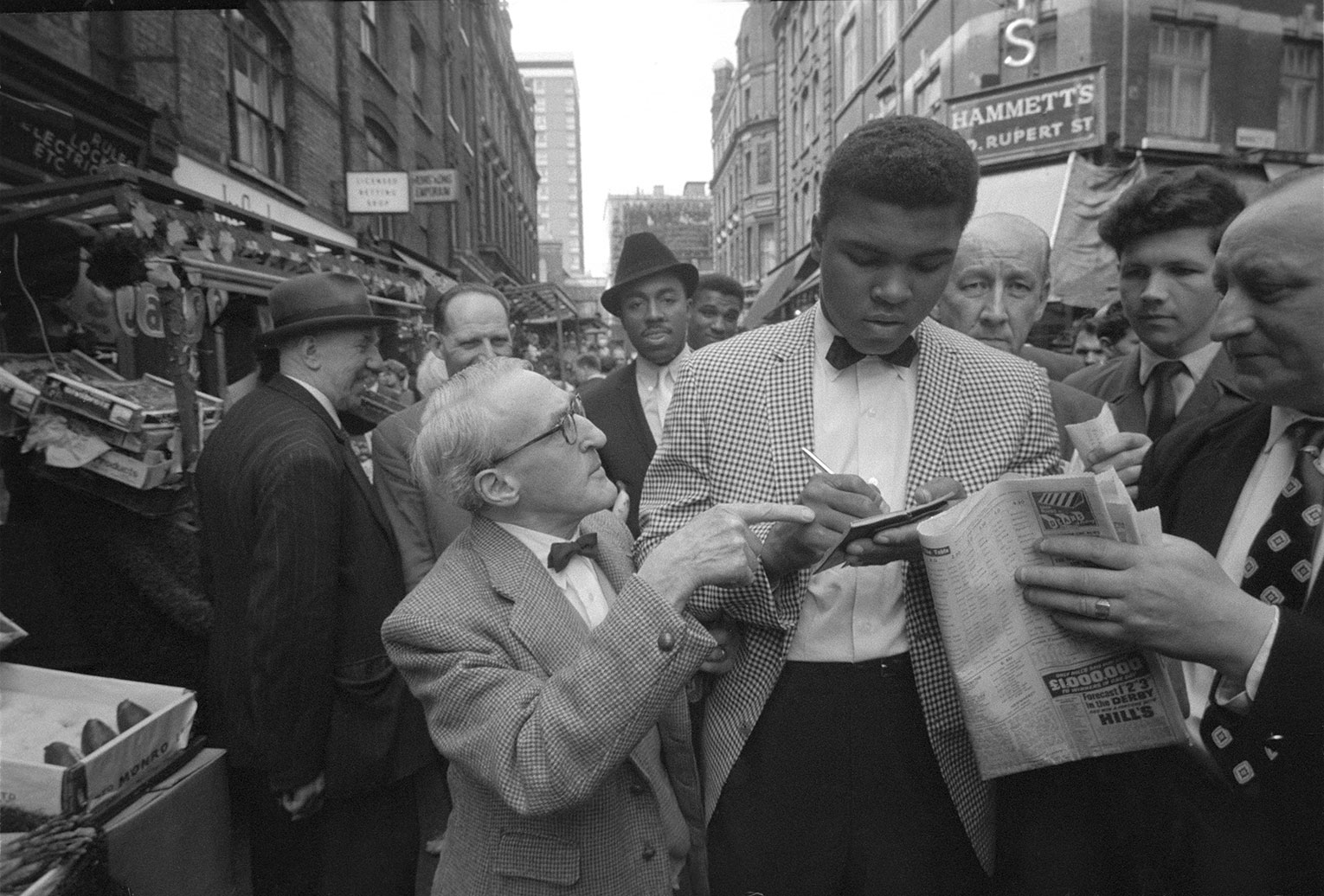 Muhammad Ali signing autographs. May 1966.