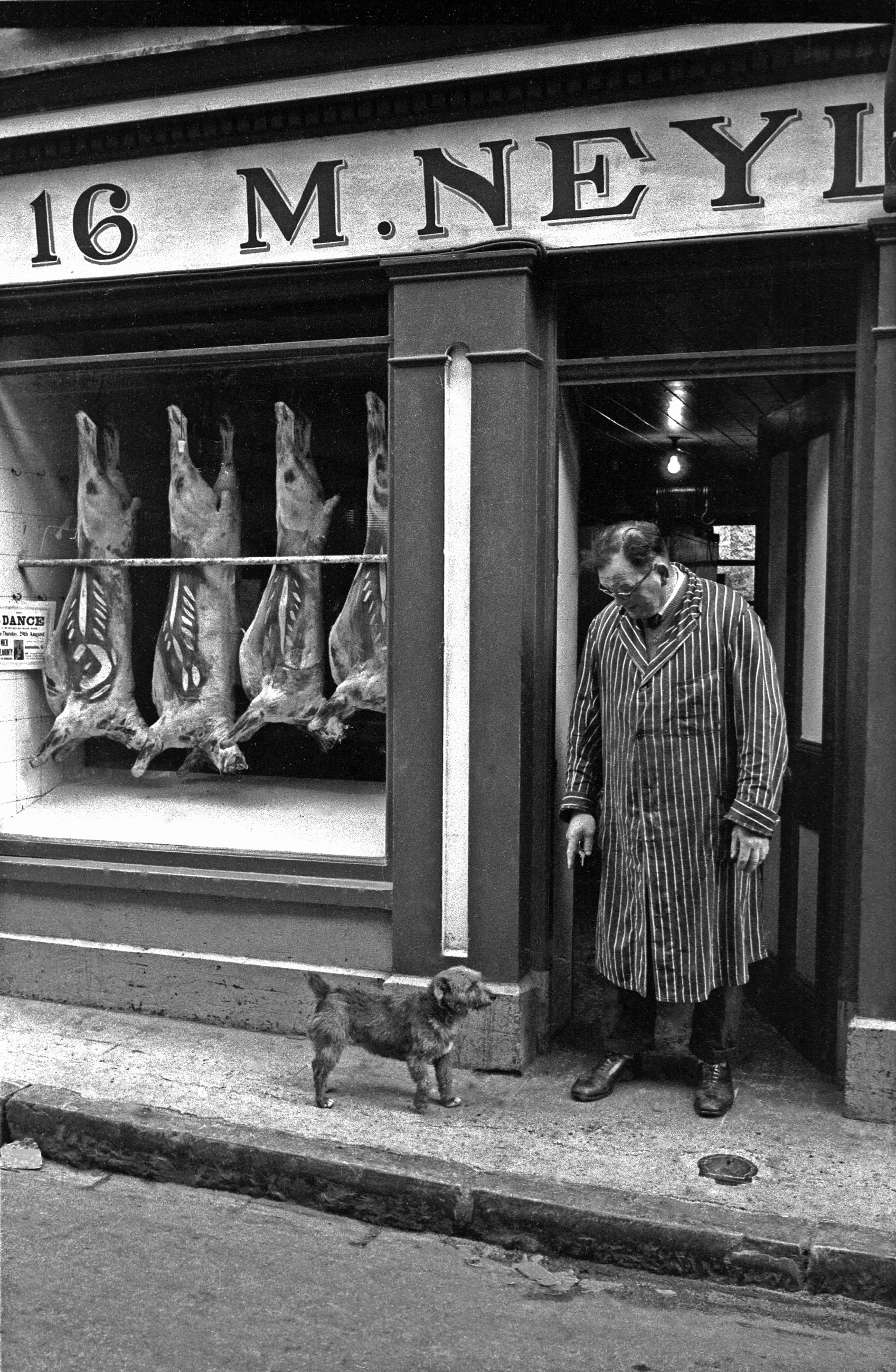 The butcher of Ennis, Ireland, and his dog. 1963.
