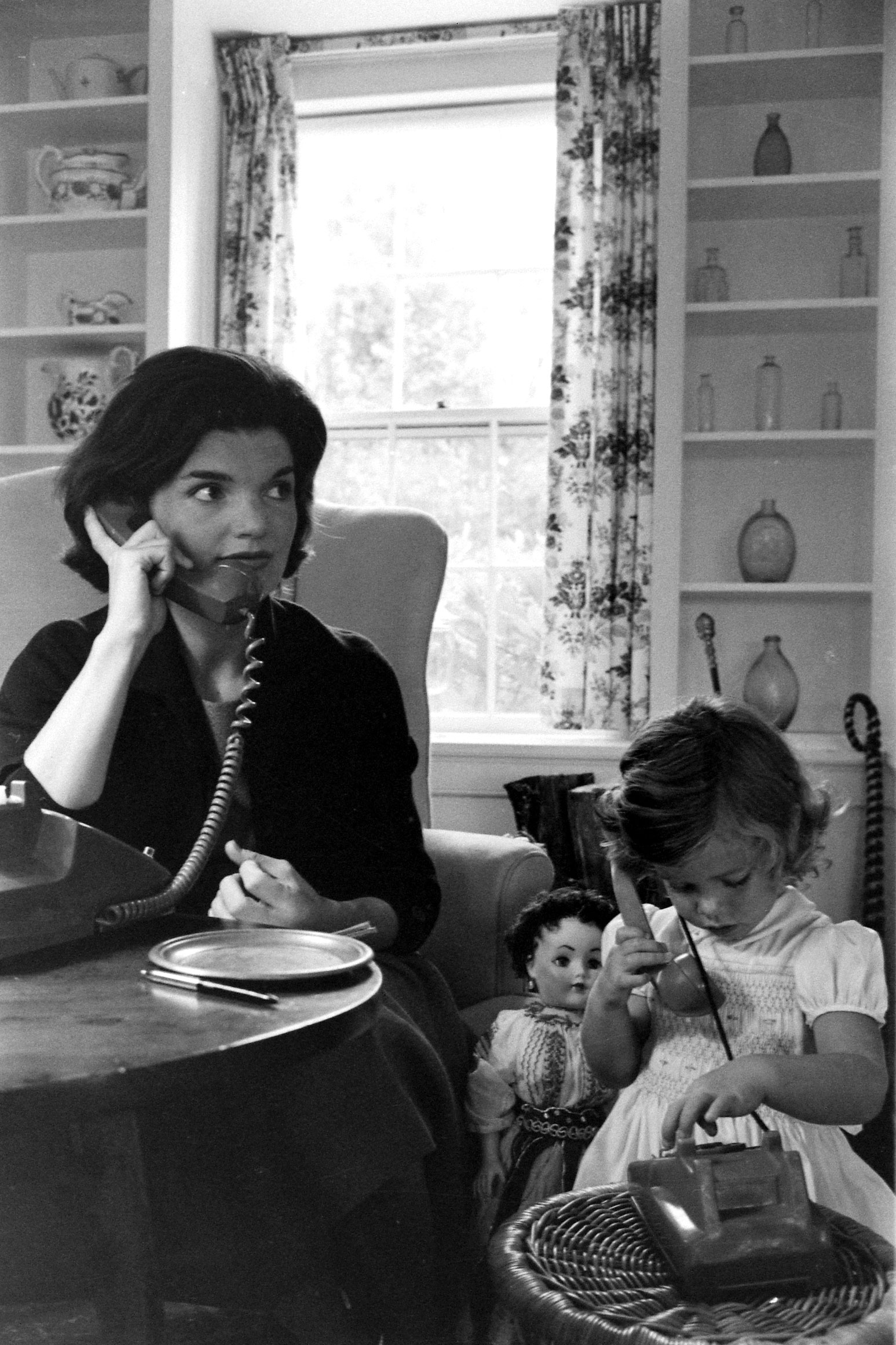 Jackie Kennedy and Caroline Kennedy on the phone, 1960.