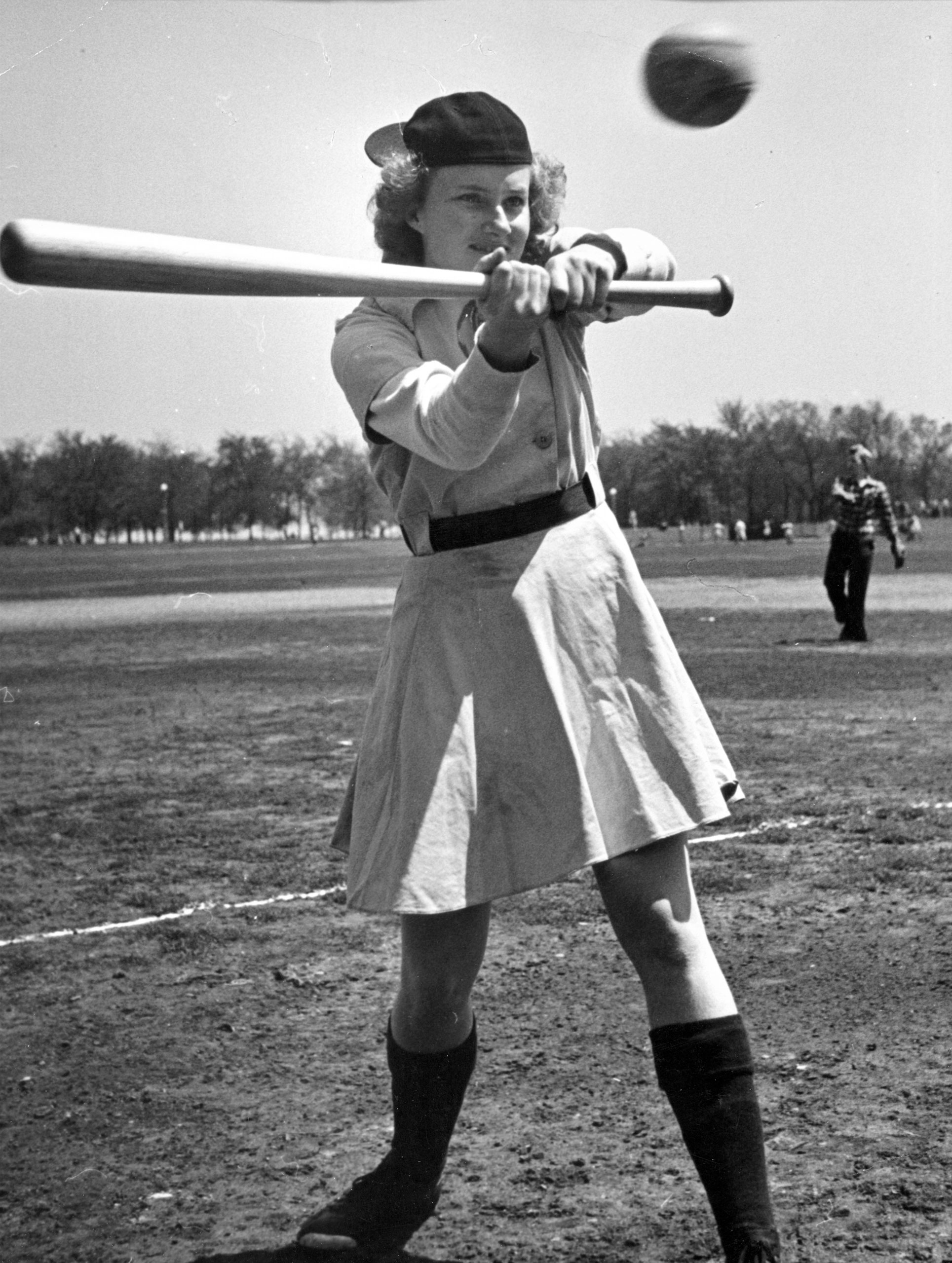 Outfielder Faye Dancer, Fort Wayne, is a heavy hitter. By league rule, skirts must be within six inches of the kneecap.