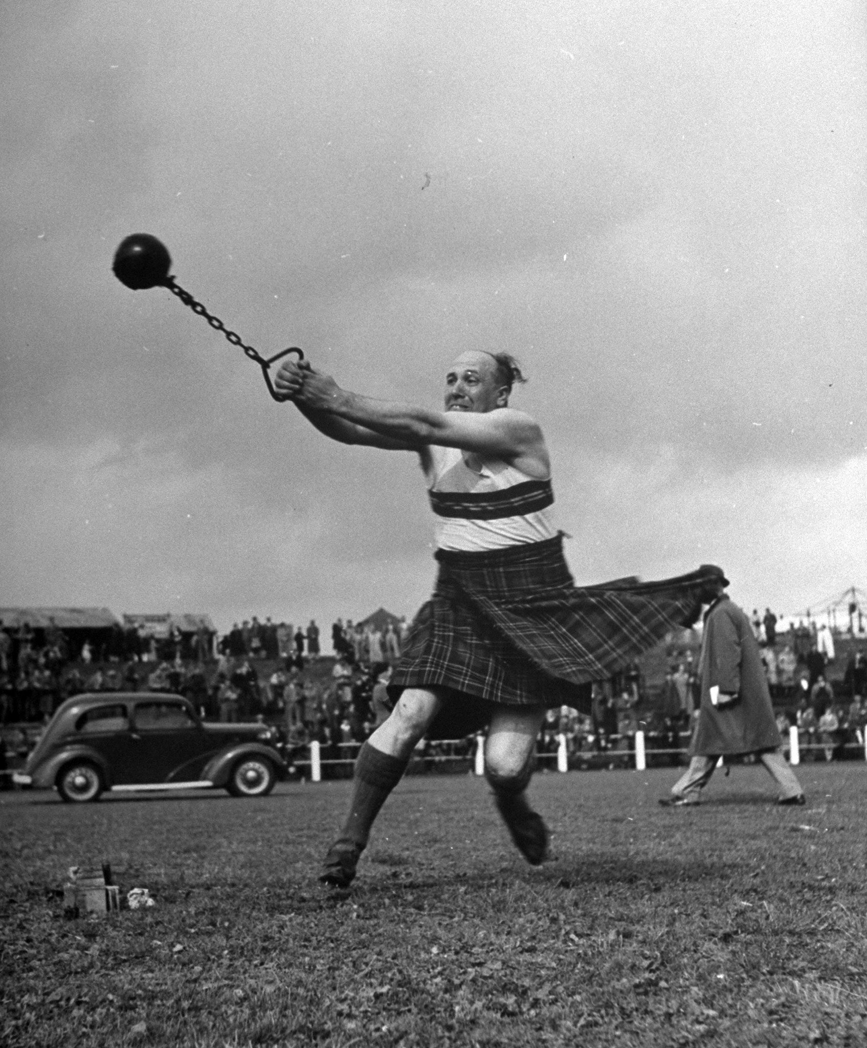 A man throwing an eight pound weight, Scotland 1947.