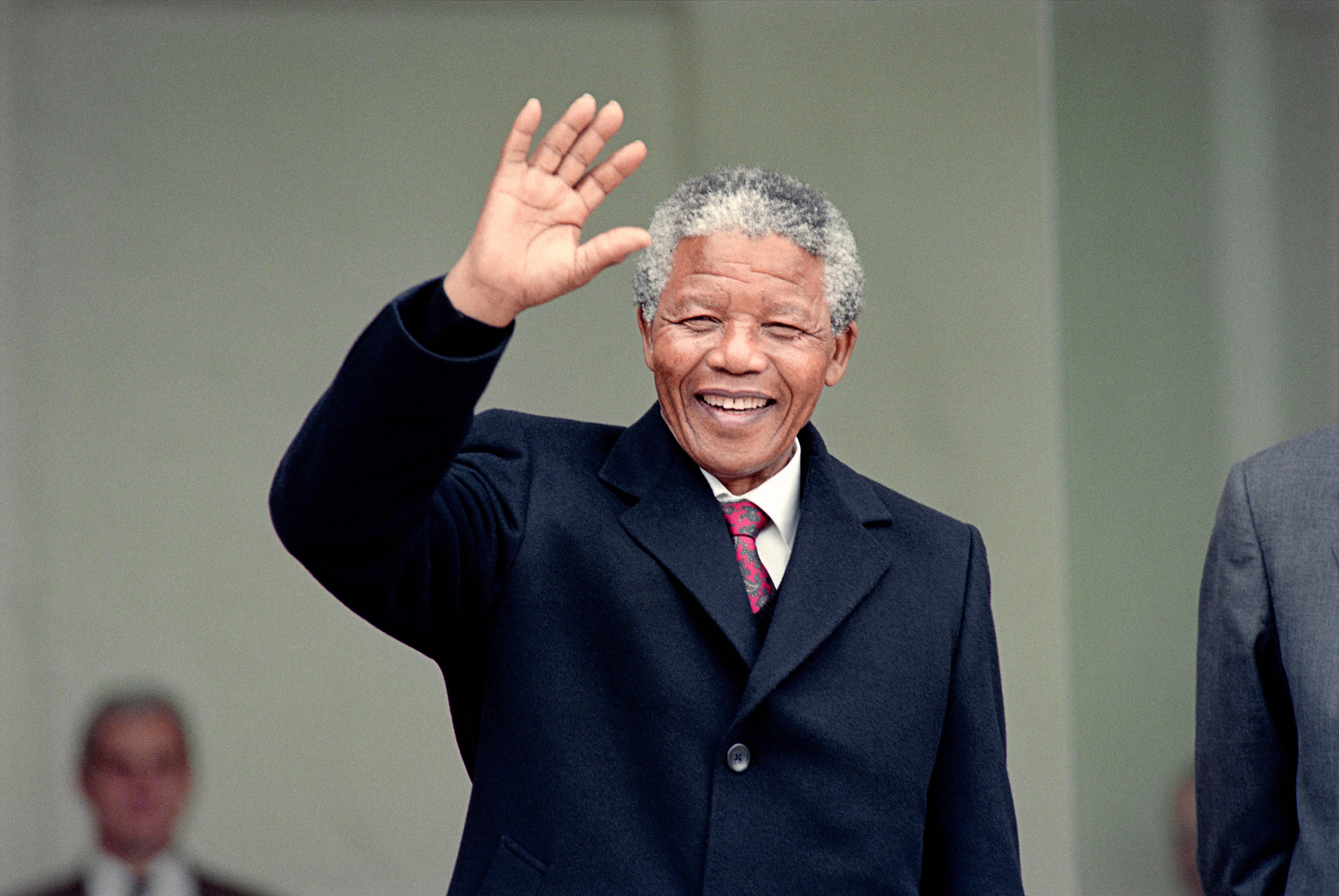 Nelson Mandela waves in Paris, June 7, 1990. (Michel Clement and Daniel Janin —AFP/Getty Images)