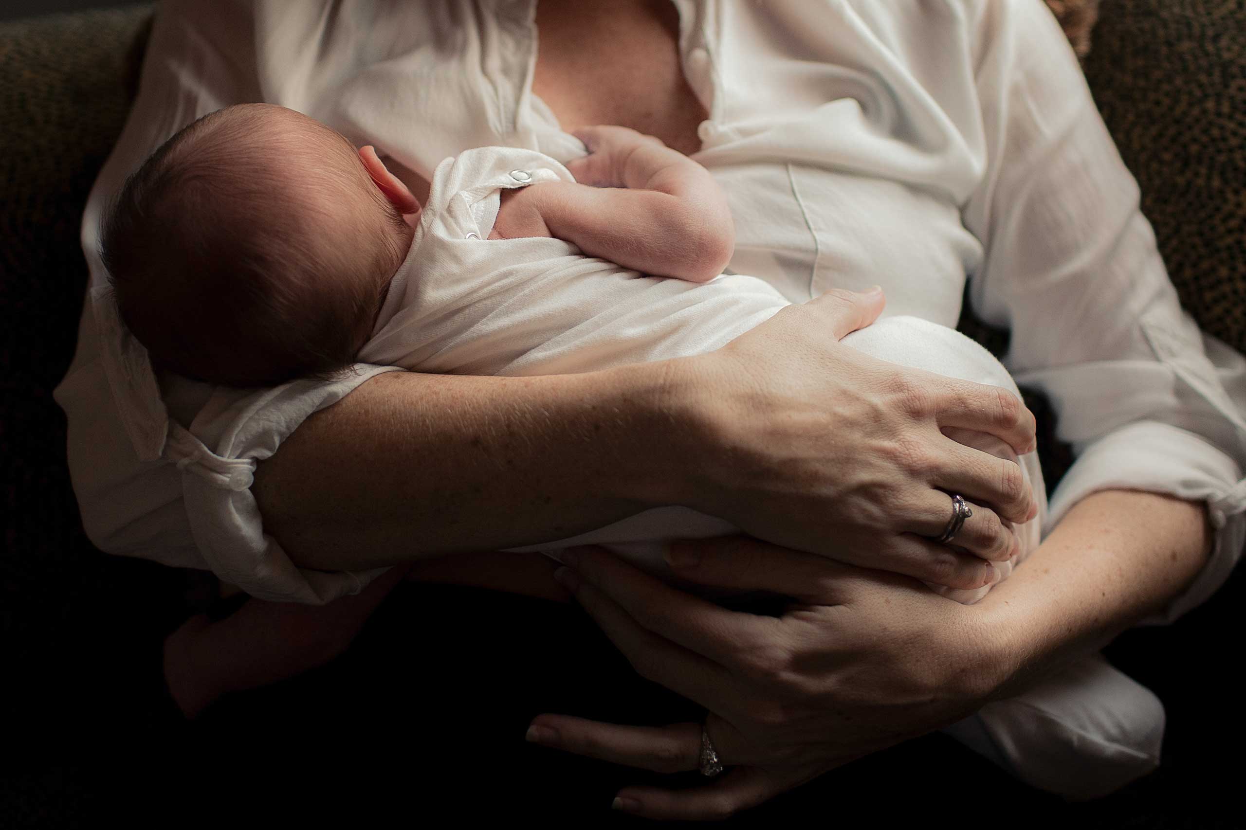 Mother holding newborn baby in arms. (Julia Wheeler and Veronika Laws —Getty Images)