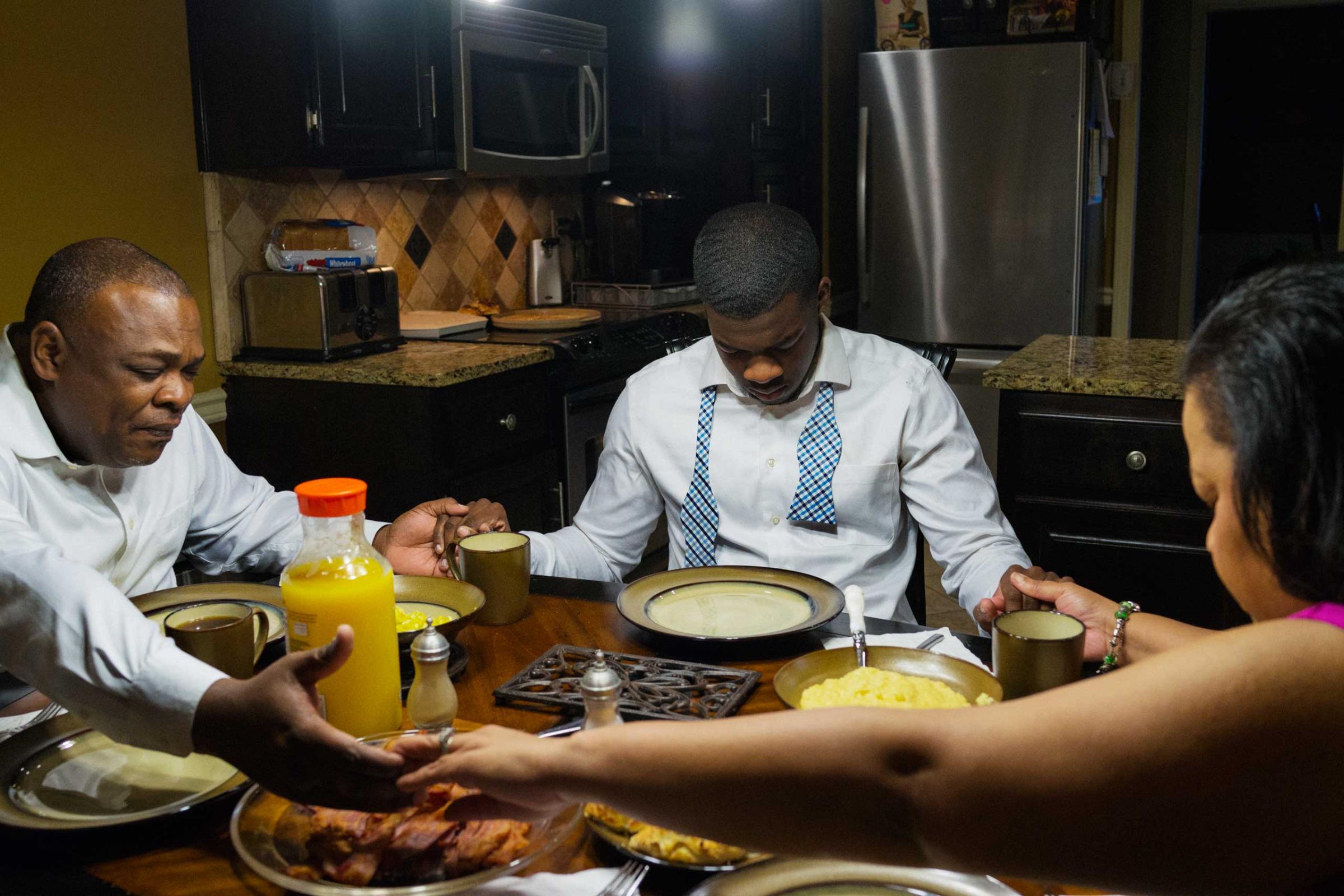 Pete Garrett prays over breakfast, with his son P.J. and wife Dr. Cynthia Garrett, at their home in Trussvile, Ala. before attending Sunday worship at the Sixteenth Street Baptist Church on March 22, 2015.