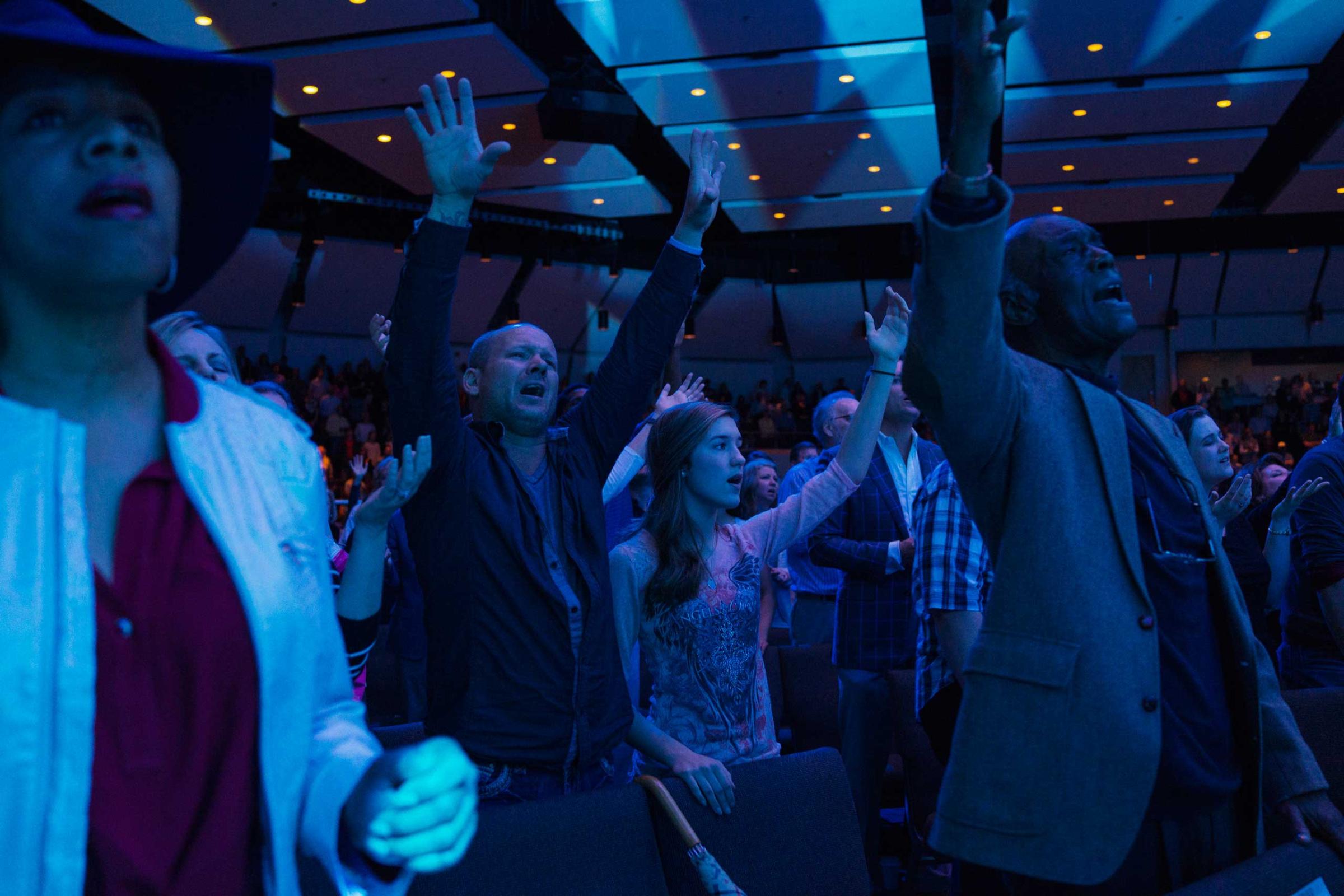 People pray and sing during worship time at Church of the Highlands in Birmingham, Ala. on March 22, 2015.