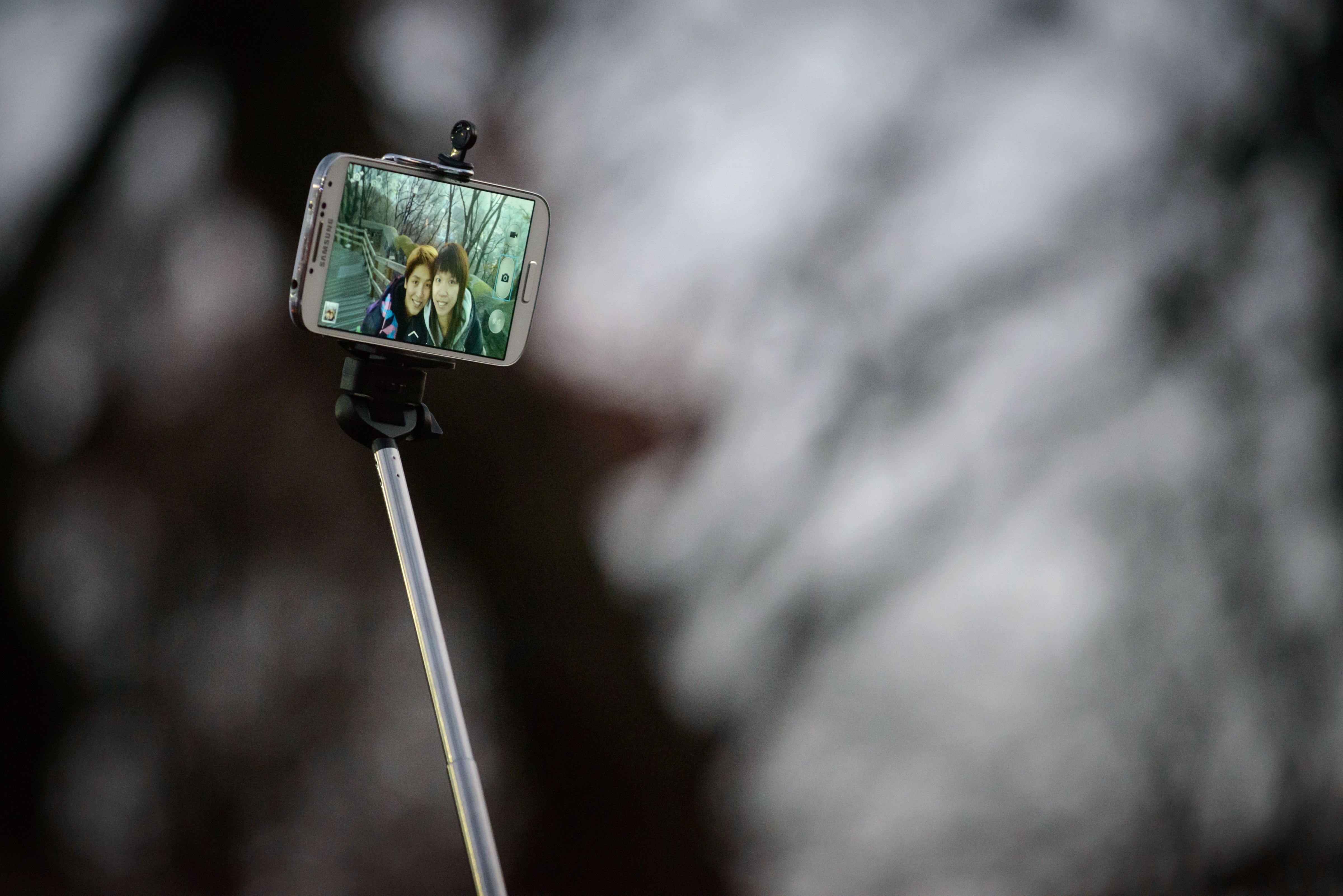 A couple use a 'selfie stick' to take a photo at a popular tourist spot in Seoul on Nov. 26, 2014.