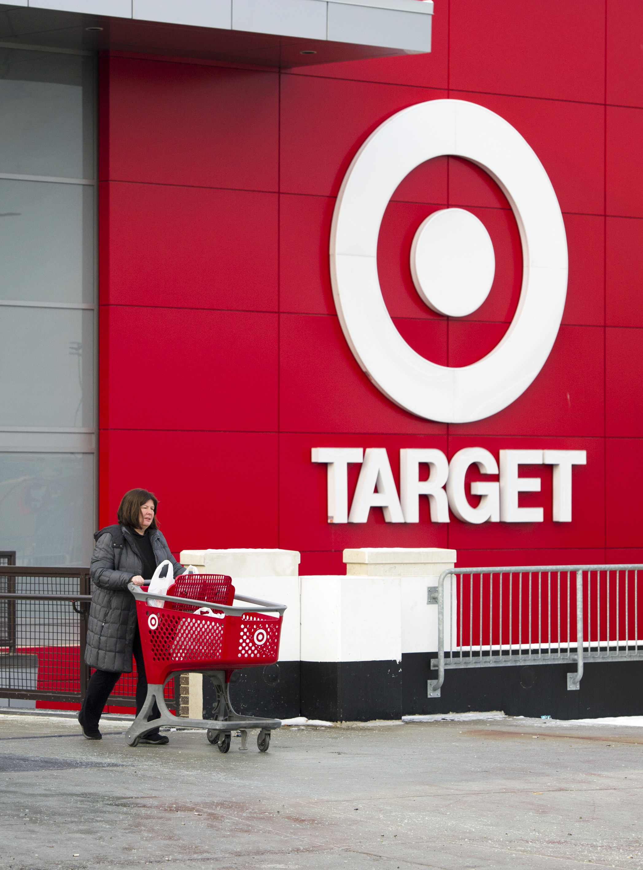 Shopper Laura Steele leaves a Target store in Toronto, Ontario, Thursday, January 15, 2015. Target announced that they will be ceasing operations in Canada affecting about 18,000 jobs. (Photo by Kevin Van Paassen Bloomberg)