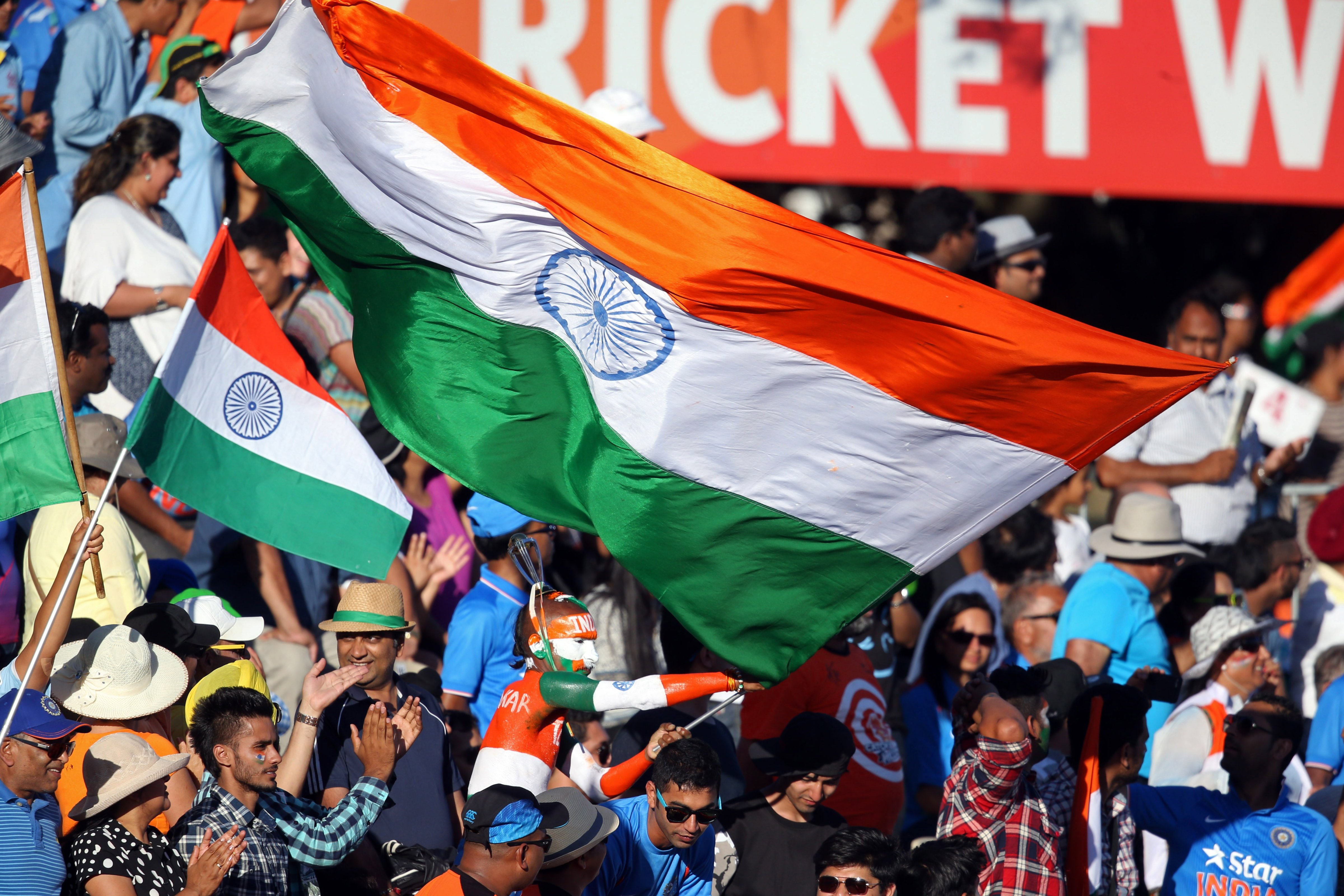 India fans wave their national flags during the Pool B Cricket World Cup match between India and Ireland at Sedden Park in Hamilton on March 10, 2015.  (MICHAEL BRADLEY—AFP/Getty Images)