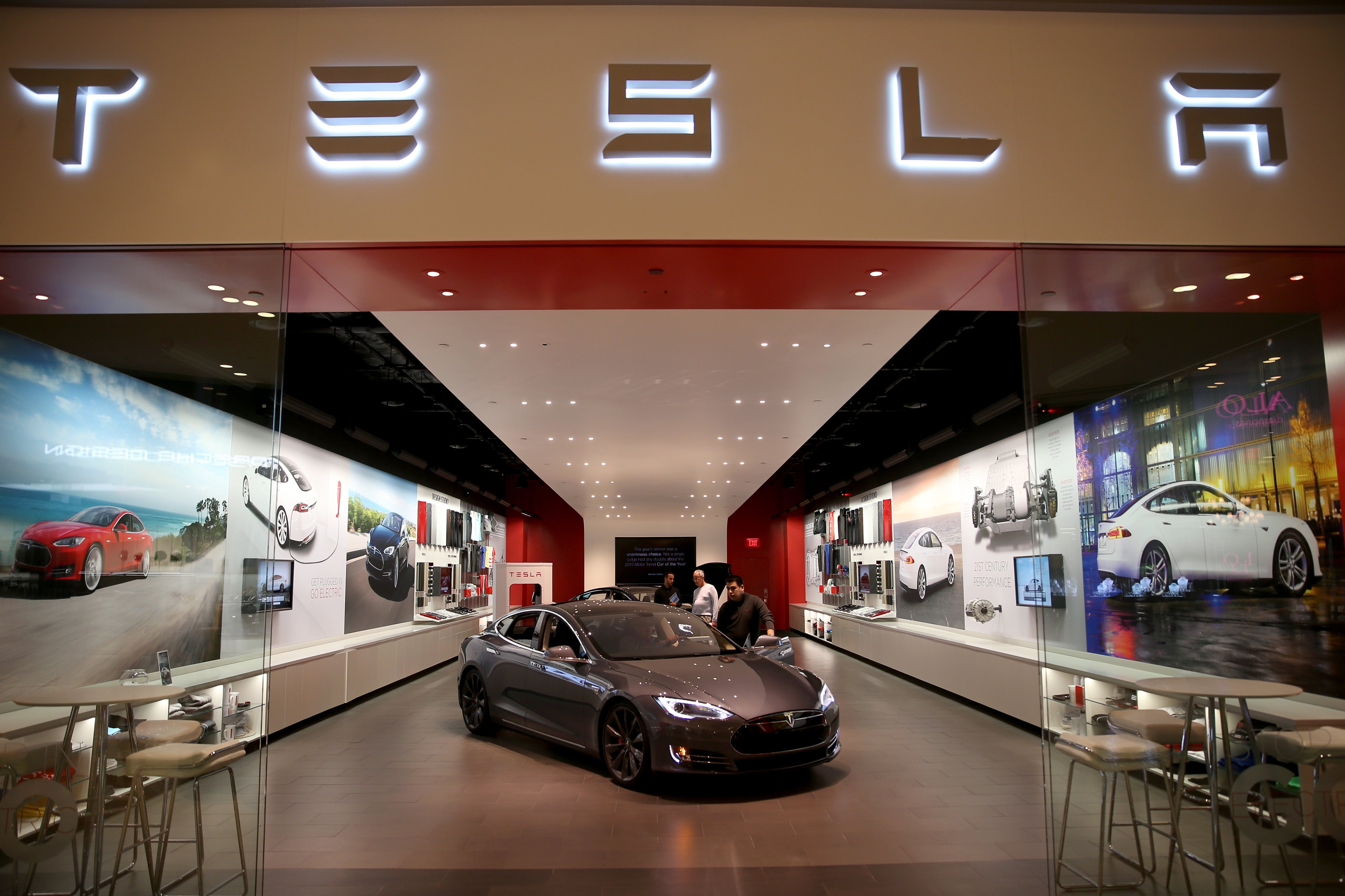 People look at a Tesla Motors vehicle on the showroom floor at the Dadeland Mall on February 19, 2014 in Miami, Florida. (Joe Raedle&mdash;Getty Images)