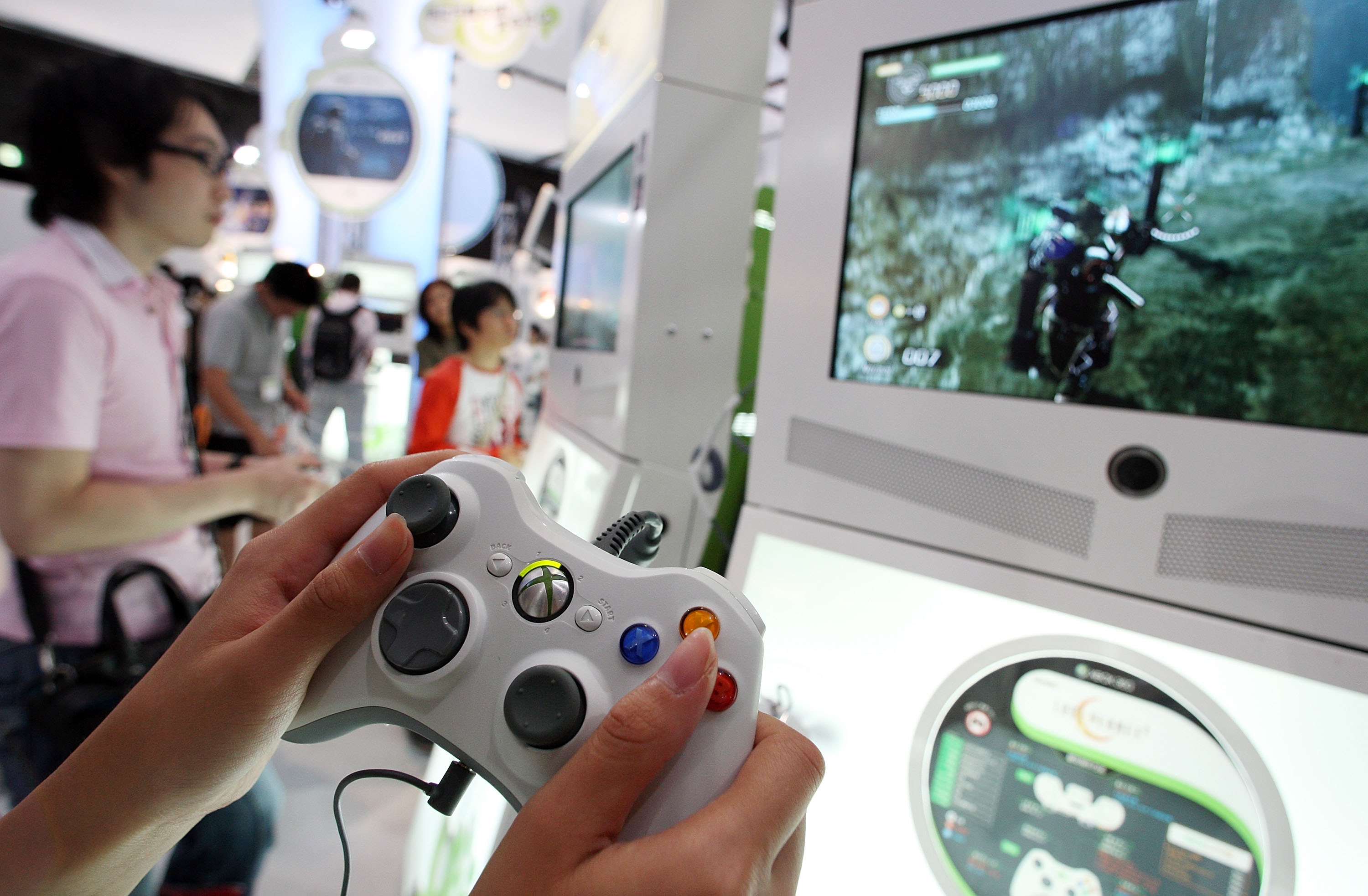 Visitors play with the XBOX 360 at the Microsoft booth during the Tokyo Game Show 2009 press and business day at Makuhari Messe on September 24, 2009 in Chiba, Japan. (Junko Kimura&mdash;Getty Images)