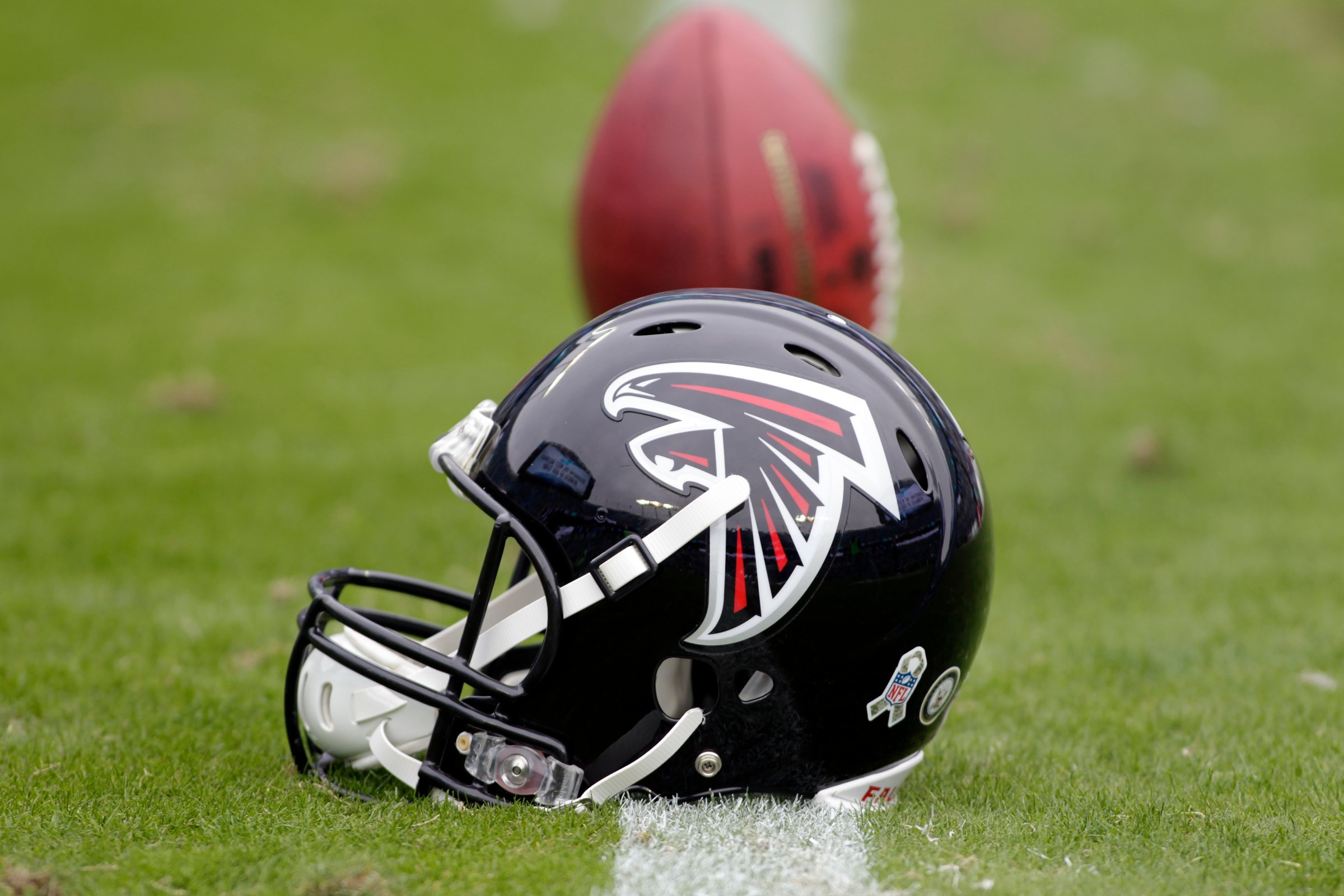 An Atlanta Falcons' helmet sits on the turf before a game against the Carolina Panthers in Charlotte, N.C. on Nov. 16, 2014.
