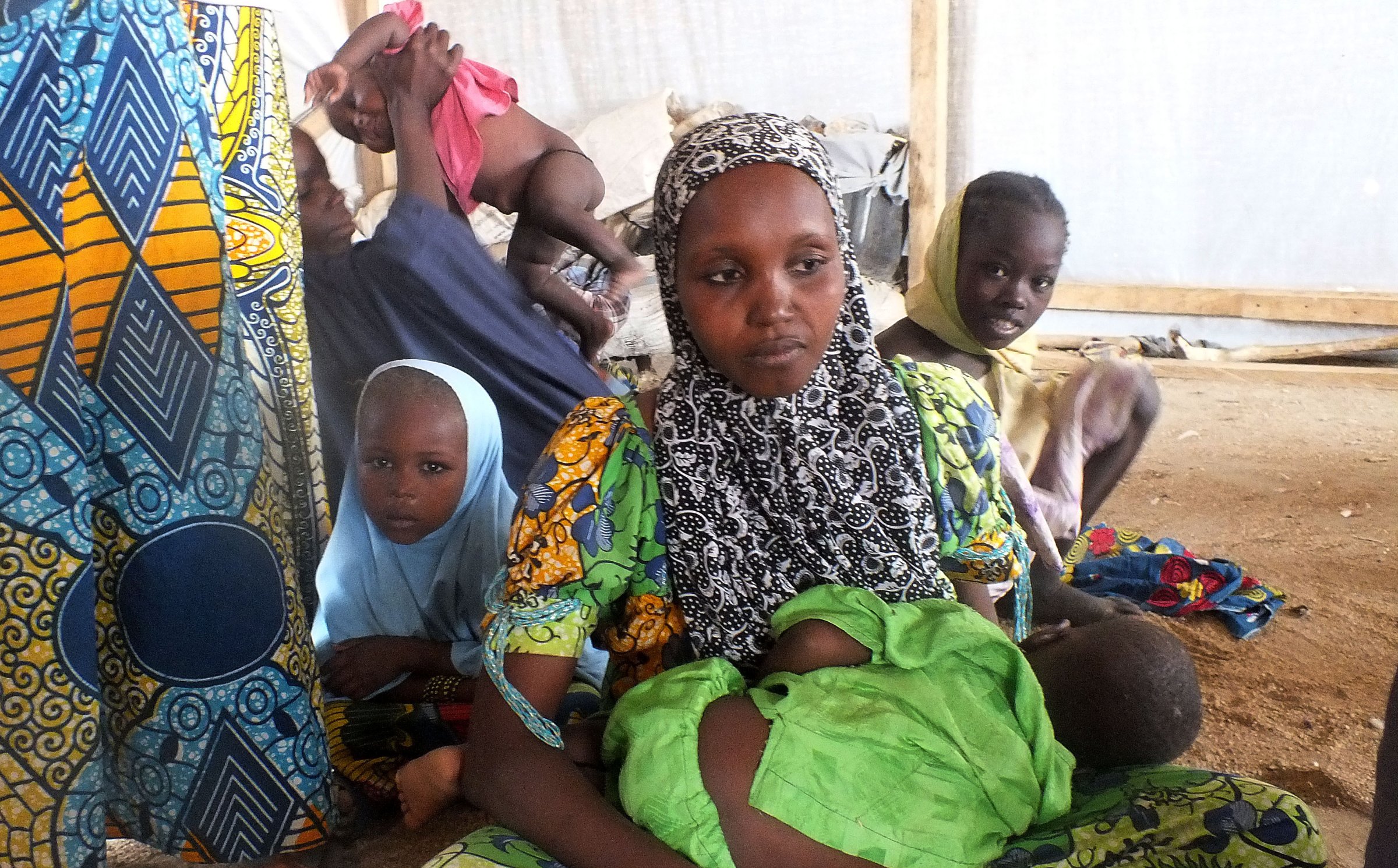 In this file photo taken on Feb. 25, 2015, a family of refugees that fled their homes due to violence from the militant group Boko Haram sit inside a refugee camp in Minawao, Cameroon
