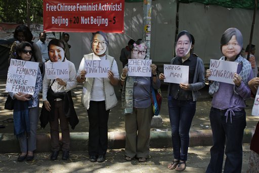 Indian women's rights activists wearing masks of five women's rights activists formally detained in China after Women's Day crackdown, hold placards with their names, to express their solidarity and demand their immediate release, in New Delhi, India, Wednesday, March 18, 2015 (Altaf Qadri—AP)