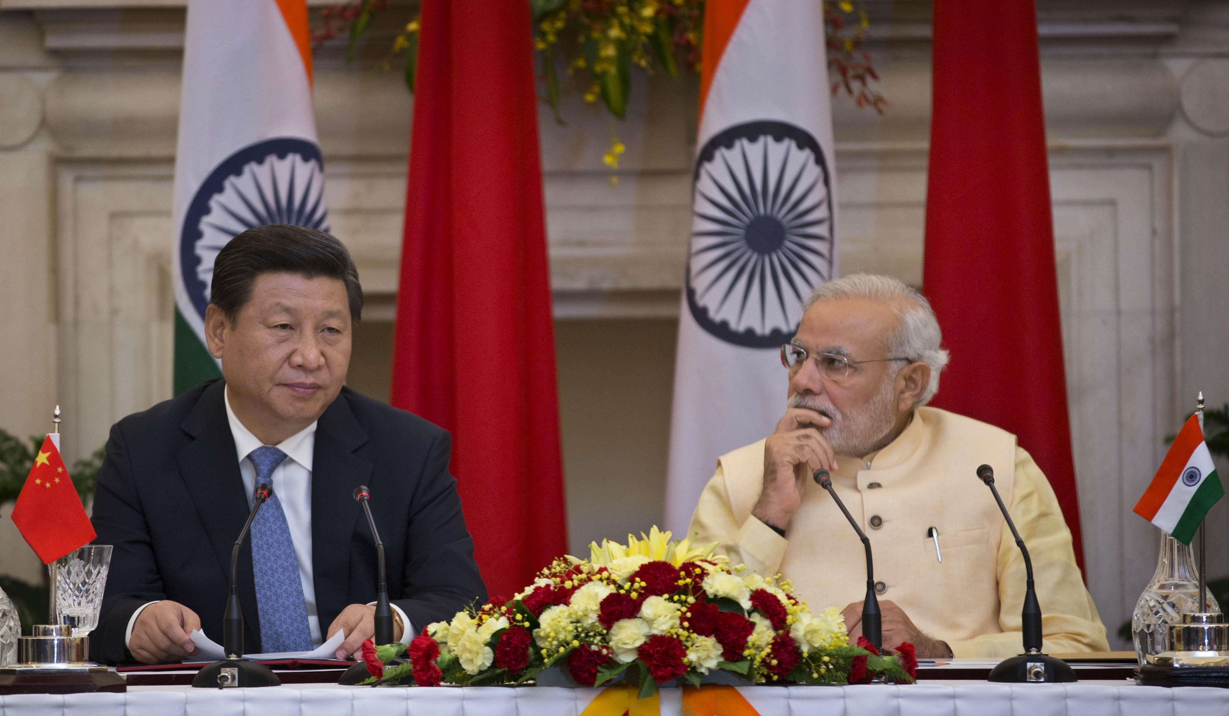 Chinese President Xi Jinping (L) makes a statement before the media as Indian Prime Minister Narendra Modi (R) watches after signing agreements in New Delhi, India on Sept. 18, 2014. (Manish Swarup—AP)