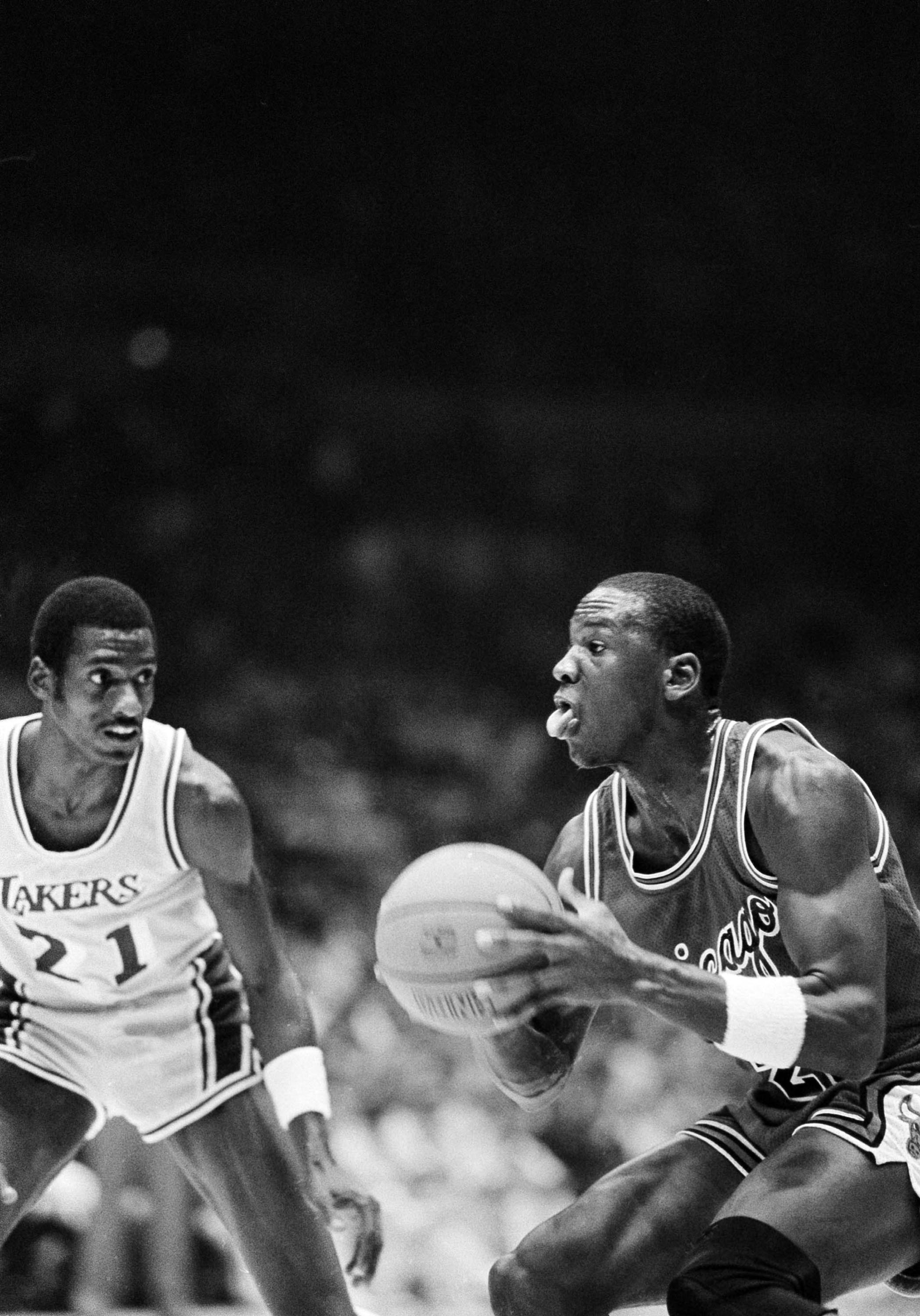 Chicago Bulls' Michael Jordan (23), right, prepares to go up with the ball as Los Angeles Lakers guard Michael Cooper (21), looks on during first half NBA action at the Forum in Inglewood, Calif., Dec. 2, 1984