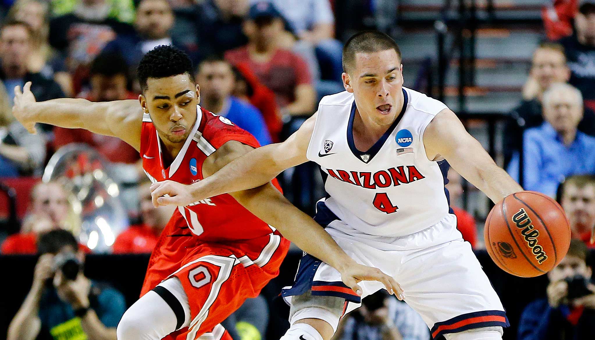 T.J. McConnell of the Arizona Wildcats and D'Angelo Russell of the Ohio State Buckeyes vie for a loose ball in the second half during the third round of the 2015 NCAA Men's Basketball Tournament at Moda Center in Portland, Ore. on March 21, 2015.