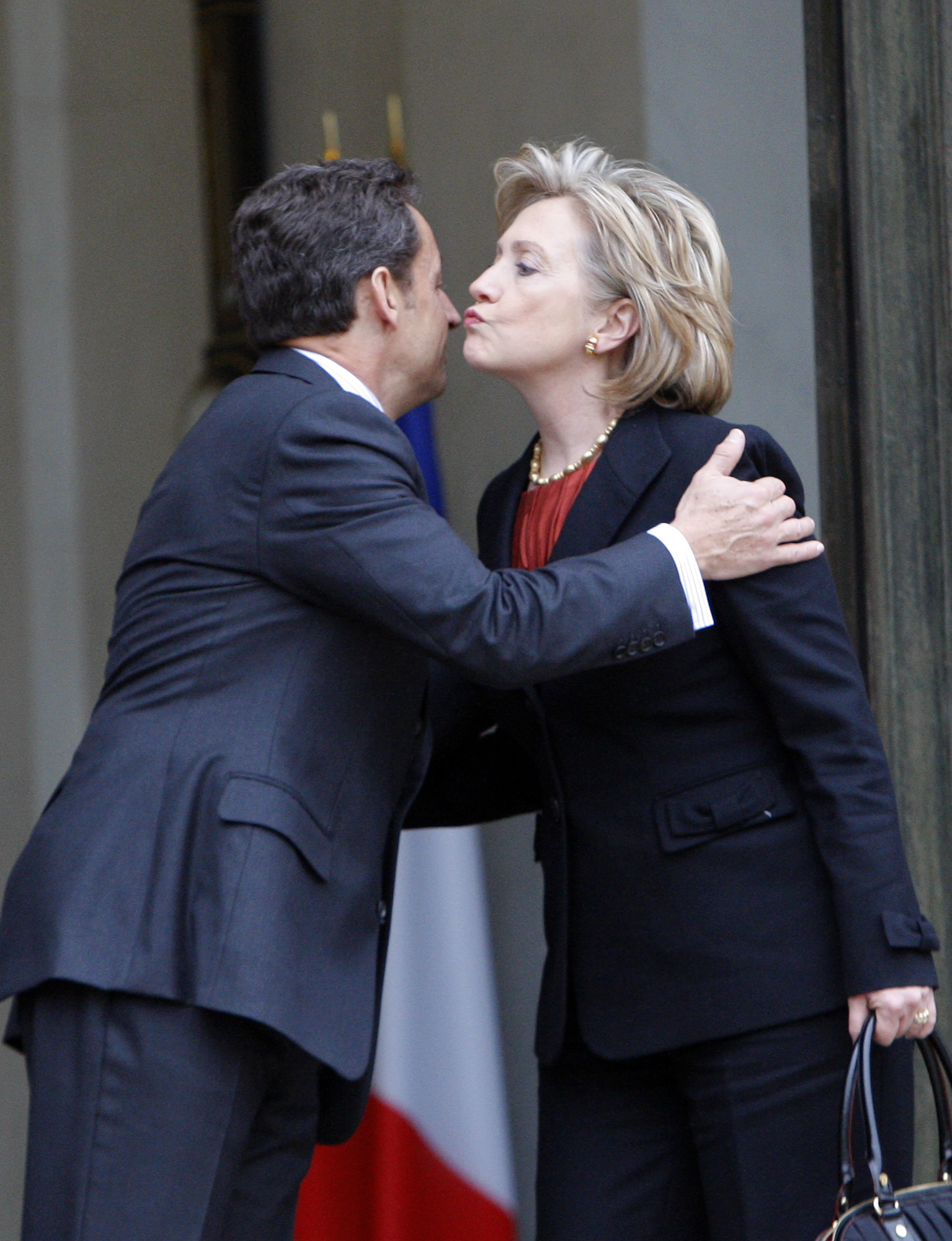 French President Nicolas Sarkozy, left, kisses goodbye to U.S. Secretary of State Hillary Rodham Clinton on the steps of the Elysee palace after their meeting on Jan. 29, 2010 in Paris.