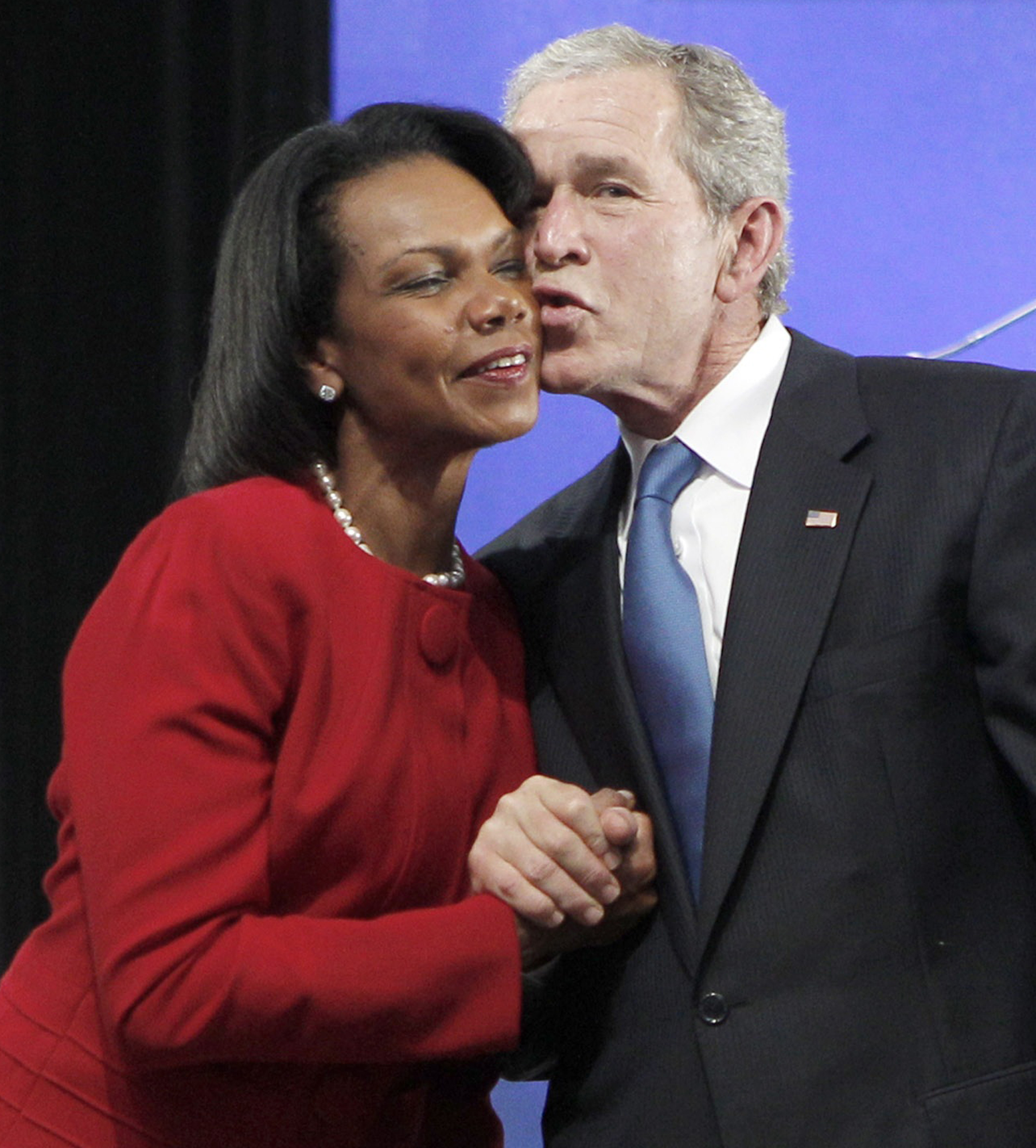 Former President George W. Bush, right, kisses former Secretary of State Condoleezza Rice during the ground breaking ceremony for the President George W. Bush Presidential Center in Dallas on Nov. 16, 2010.