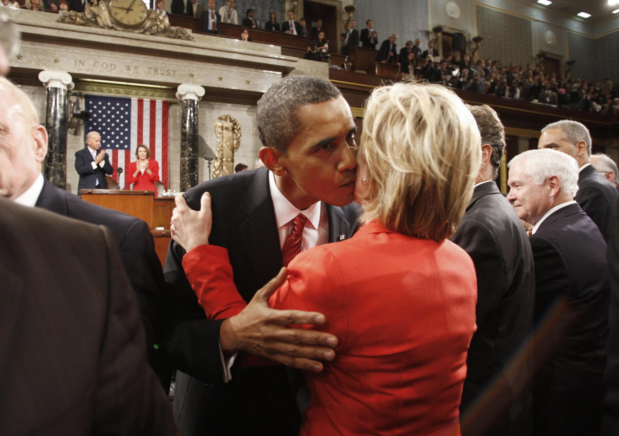 US President Barack Obama kisses Hillary Clinton