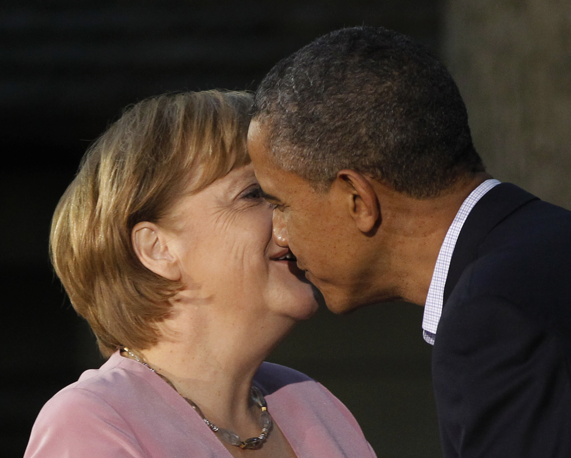 President Barack Obama gives German Chancellor Angela Merkel a kiss on the cheek on arrival for the G8 Summit on May 18, 2012 at Camp David, Md.