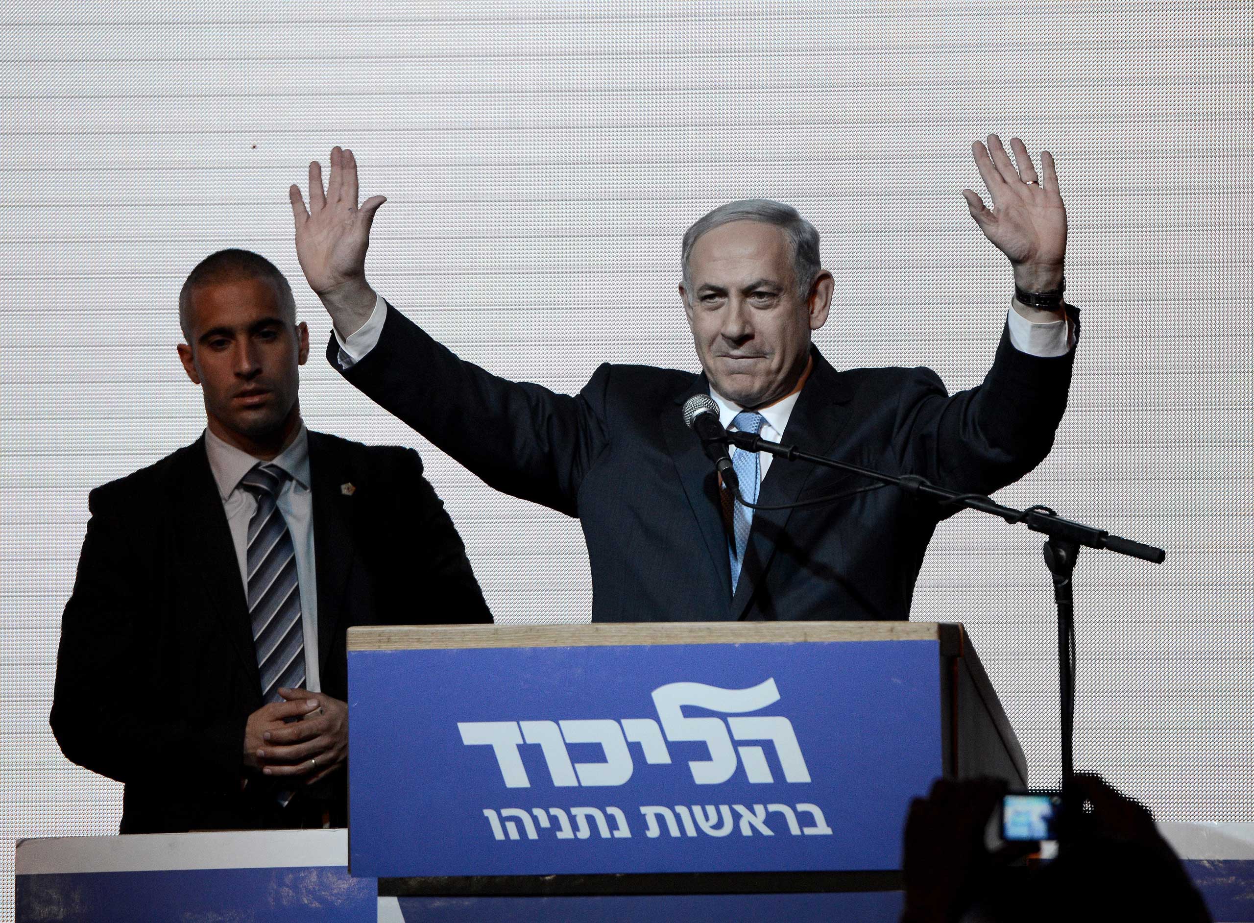 Israeli Prime Minister and the leader of the Likud Party Benjamin Netanyahu greets supporters at the party's election headquarters after the first results of the Israeli general election on March 18, 2015 in Tel Aviv, Israel. (Salih Zeki Fazlioglu—Anadolu Agency/Getty Images)