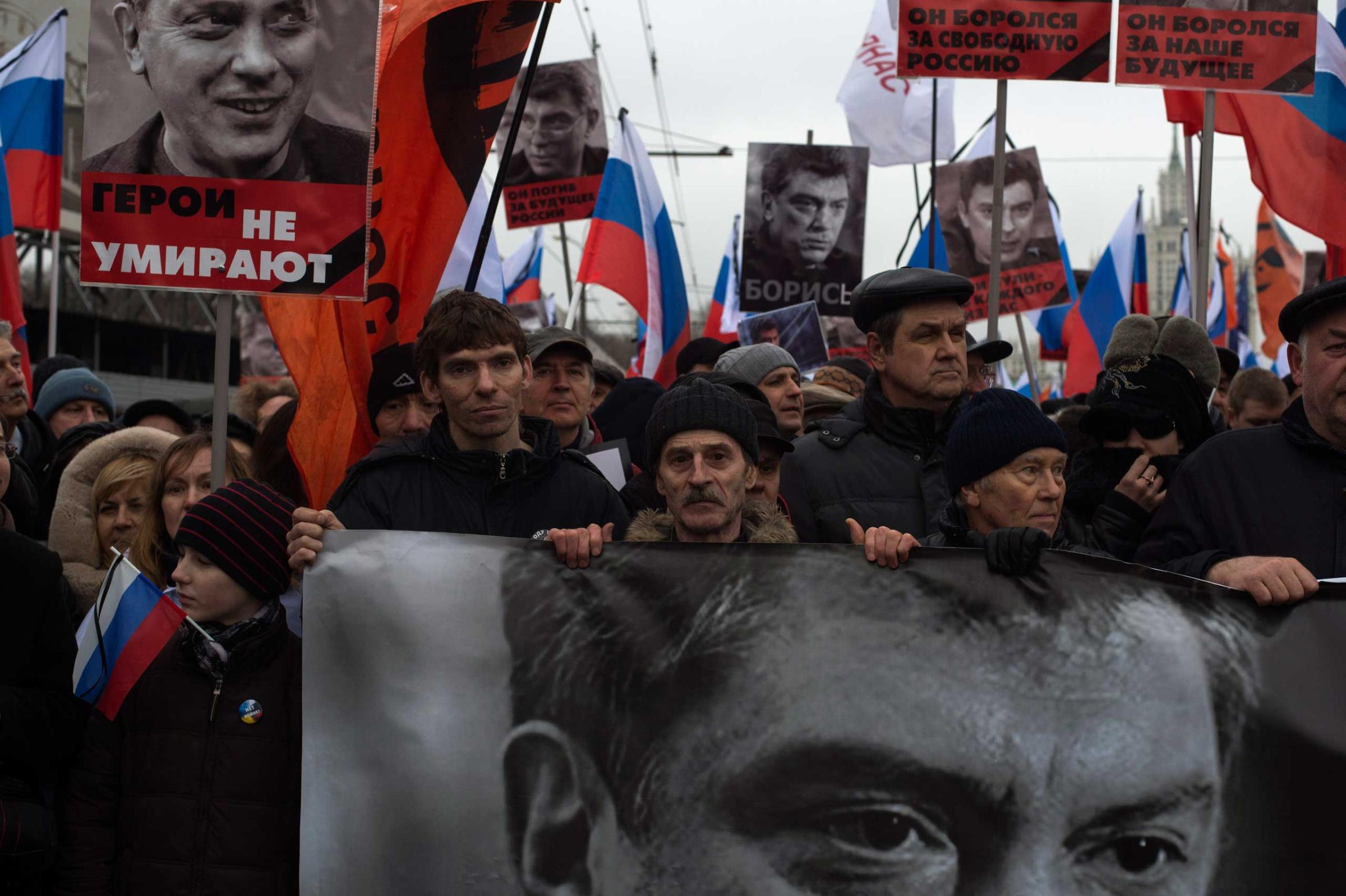 Moscow, Russia, Sunday, March 1, 2015. People carry a huge banner reading 'those bullets for everyone of us, heroes never die!' as they march in memory of opposition leader Boris Nemtsov who was gunned down on Friday, Feb. 27, 2015 near the Kremlin.Thousands converged Sunday in central Moscow to mourn veteran liberal politician Boris Nemtsov, whose killing on the streets of the capital has shaken Russia’s beleaguered opposition. They carried flowers, portraits and white signs that said “I am not afraid.”