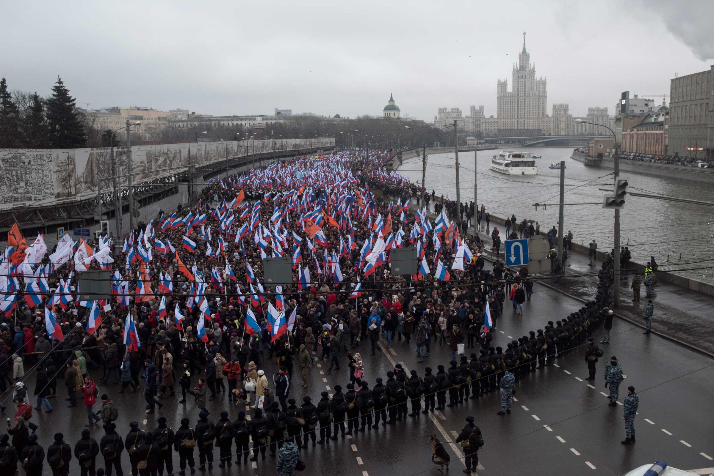 Moscow, Russia, Sunday, March 1, 2015. People carry a huge banner reading 'those bullets for everyone of us, heroes never die!' as they march in memory of opposition leader Boris Nemtsov who was gunned down on Friday, Feb. 27, 2015 near the Kremlin.Thousands converged Sunday in central Moscow to mourn veteran liberal politician Boris Nemtsov, whose killing on the streets of the capital has shaken Russia’s beleaguered opposition. They carried flowers, portraits and white signs that said “I am not afraid.”