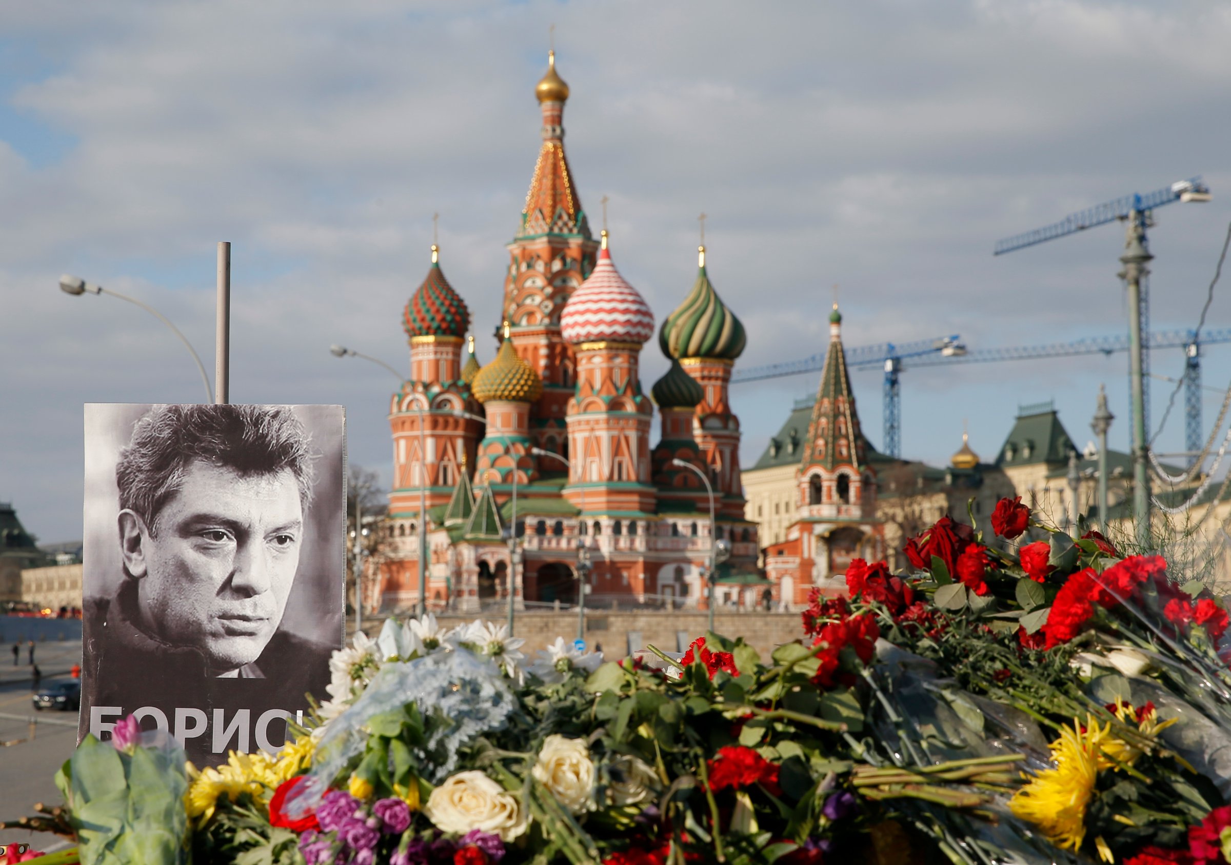 A portrait of Kremlin critic Boris Nemtsov and flowers are pictured at the site where he was killed on Feb. 27, 2015 with St. Basil's Cathedral seen in the background, at the Great Moskvoretsky Bridge in central Moscow on March 6, 2015.