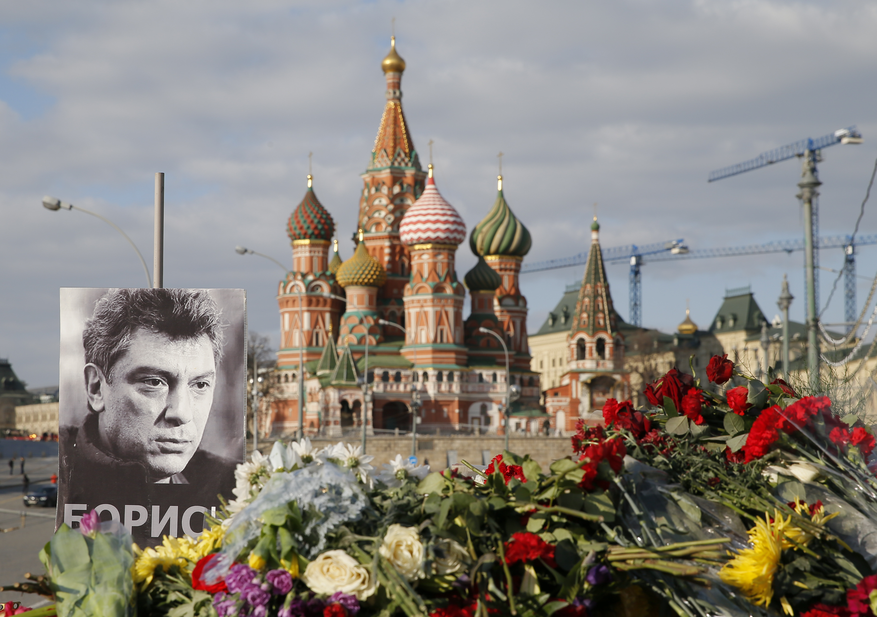A portrait of Kremlin critic Boris Nemtsov and flowers are pictured at the site where he was killed on Feb. 27, 2015 with St. Basil's Cathedral seen in the background, at the Great Moskvoretsky Bridge in central Moscow on March 6, 2015. (Maxim Shemetov—Reuters)