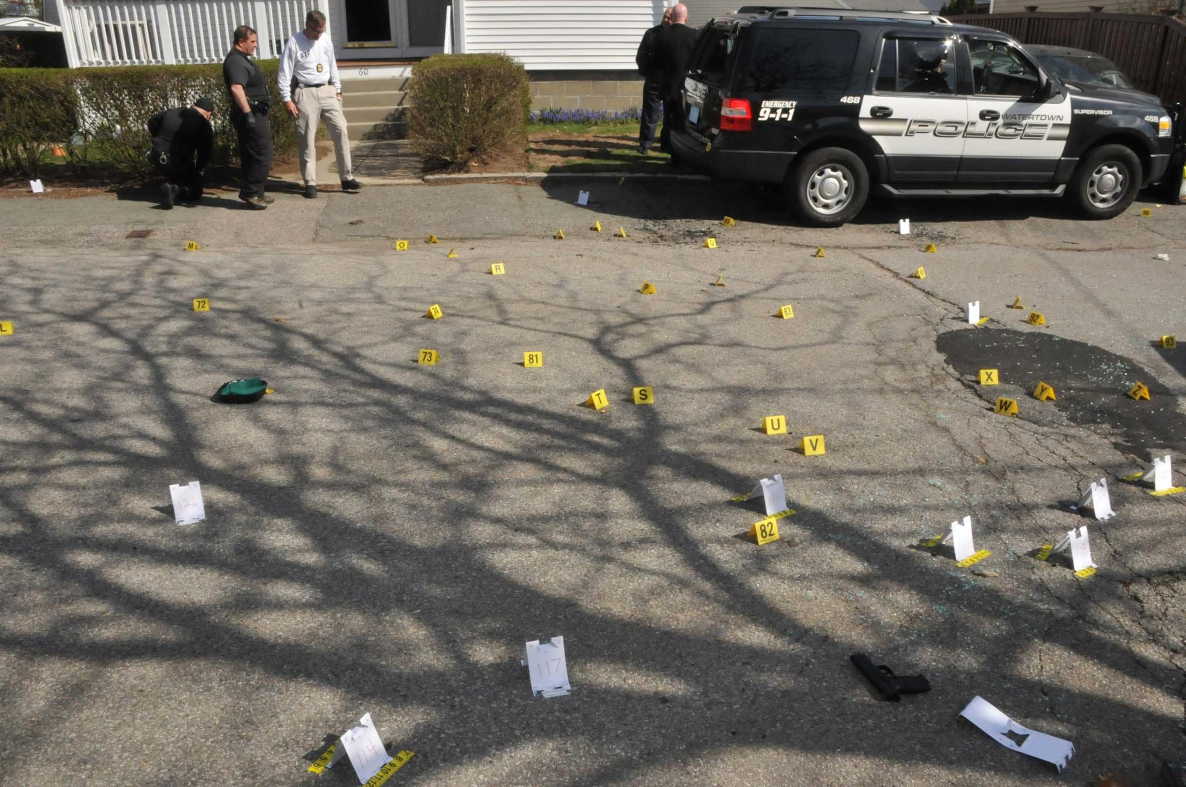 Evidence markers are seen on a street where Tamerlan and Dzhokhar Tsarnaev engaged in a gunfight with police in this undated handout evidence photo
