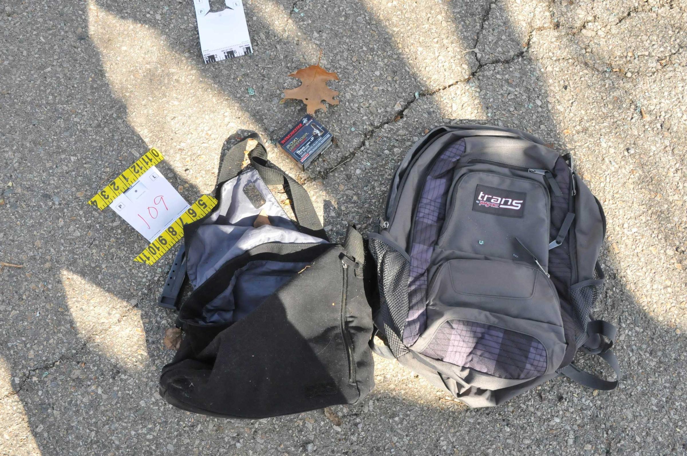 A 9mm Luger clip and bullet package sit next to a backpack and bag on a street where Tamerlan and Dzhokhar Tsarnaev engaged in a gunfight with police in this undated handout evidence photo