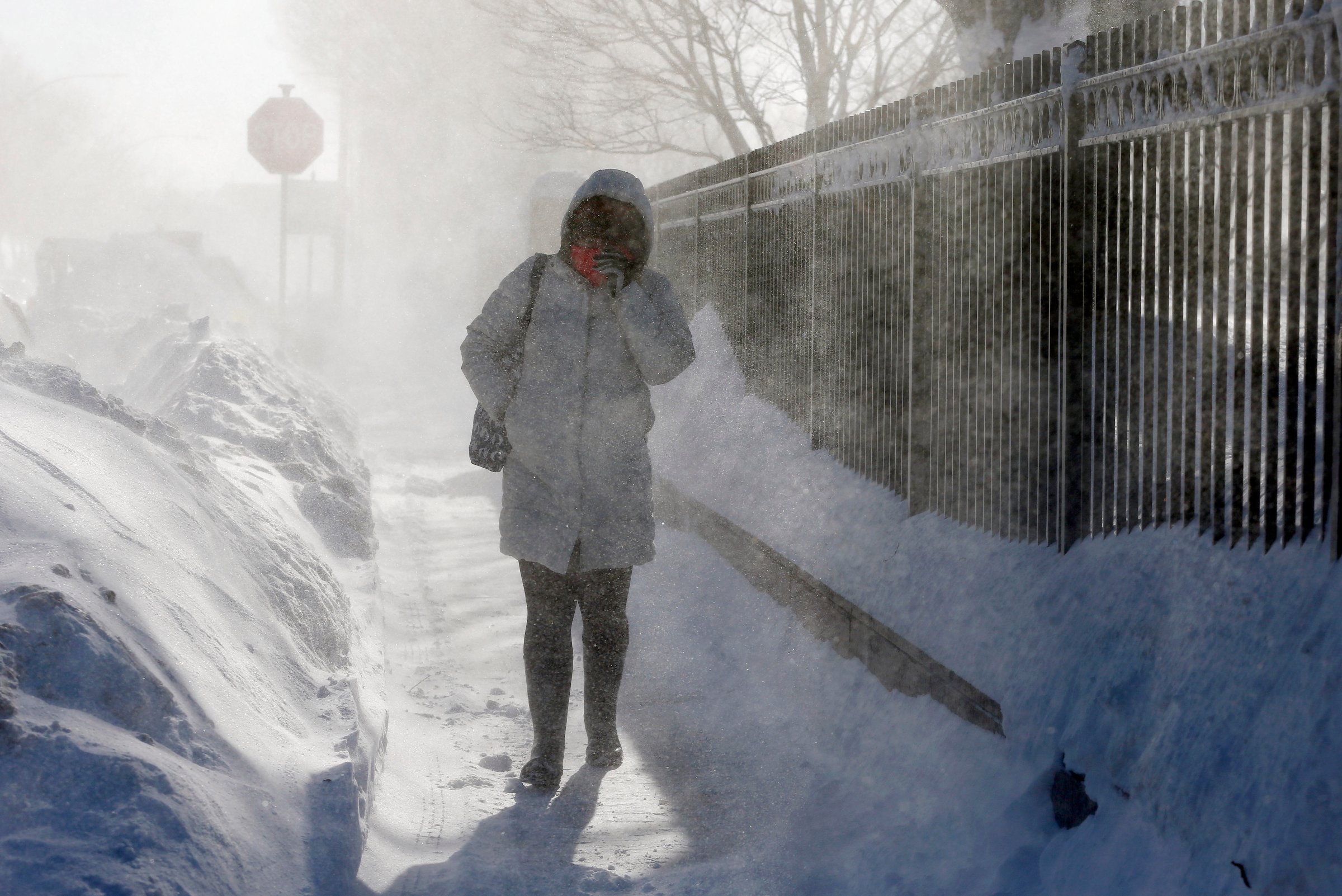 A woman walks through blowing snow in the East Boston neighborhood of Boston, Monday, Feb. 16, 2015