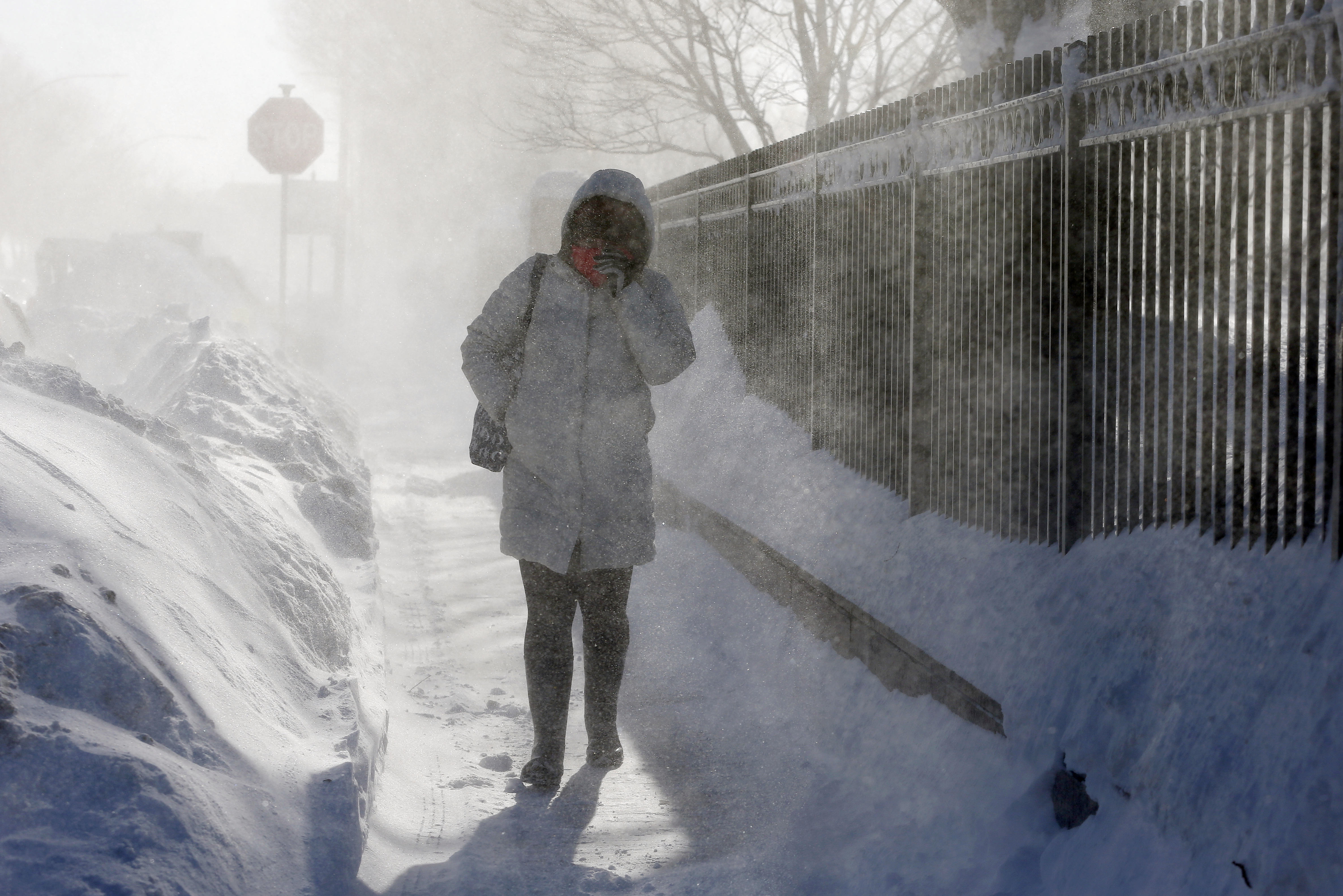 A woman walks through blowing snow in the East Boston neighborhood of Boston, Monday, Feb. 16, 2015 (Michael Dwyer—AP)