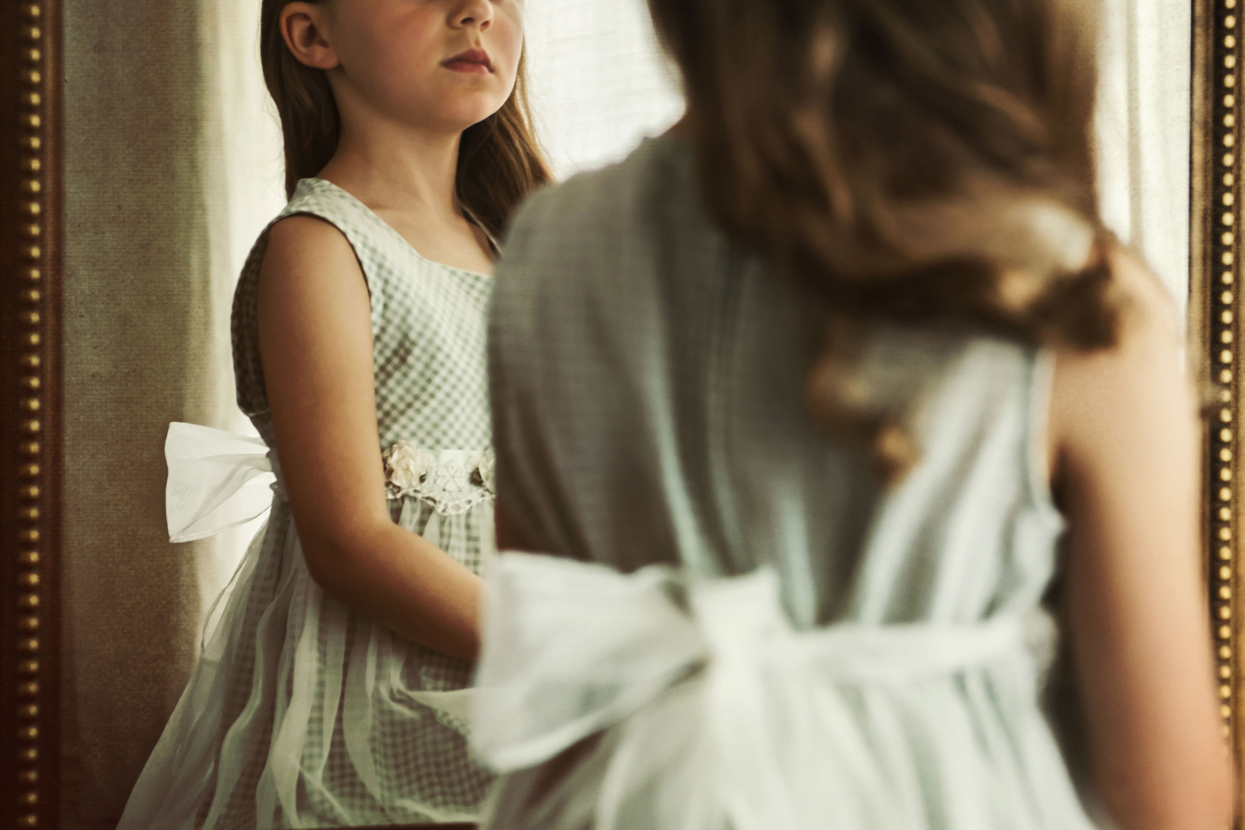 A young girl's reflection in the mirror