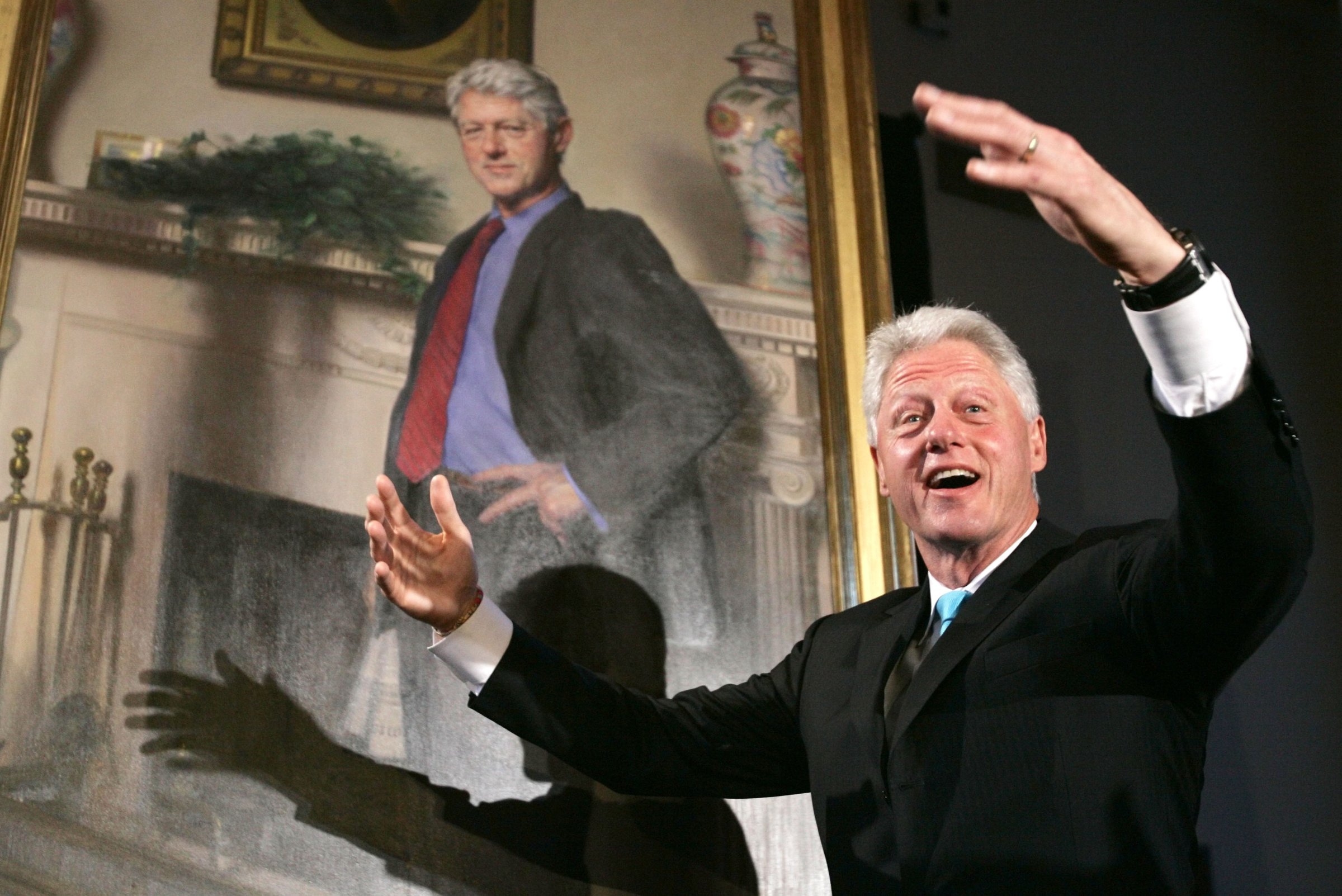 Former President Bill Clinton gestures after the portraits of his wife, Hillary Rodham Clinton and him, were revealed on April 24, 2006 at the Smithsonian Castle Building in Washington D.C.