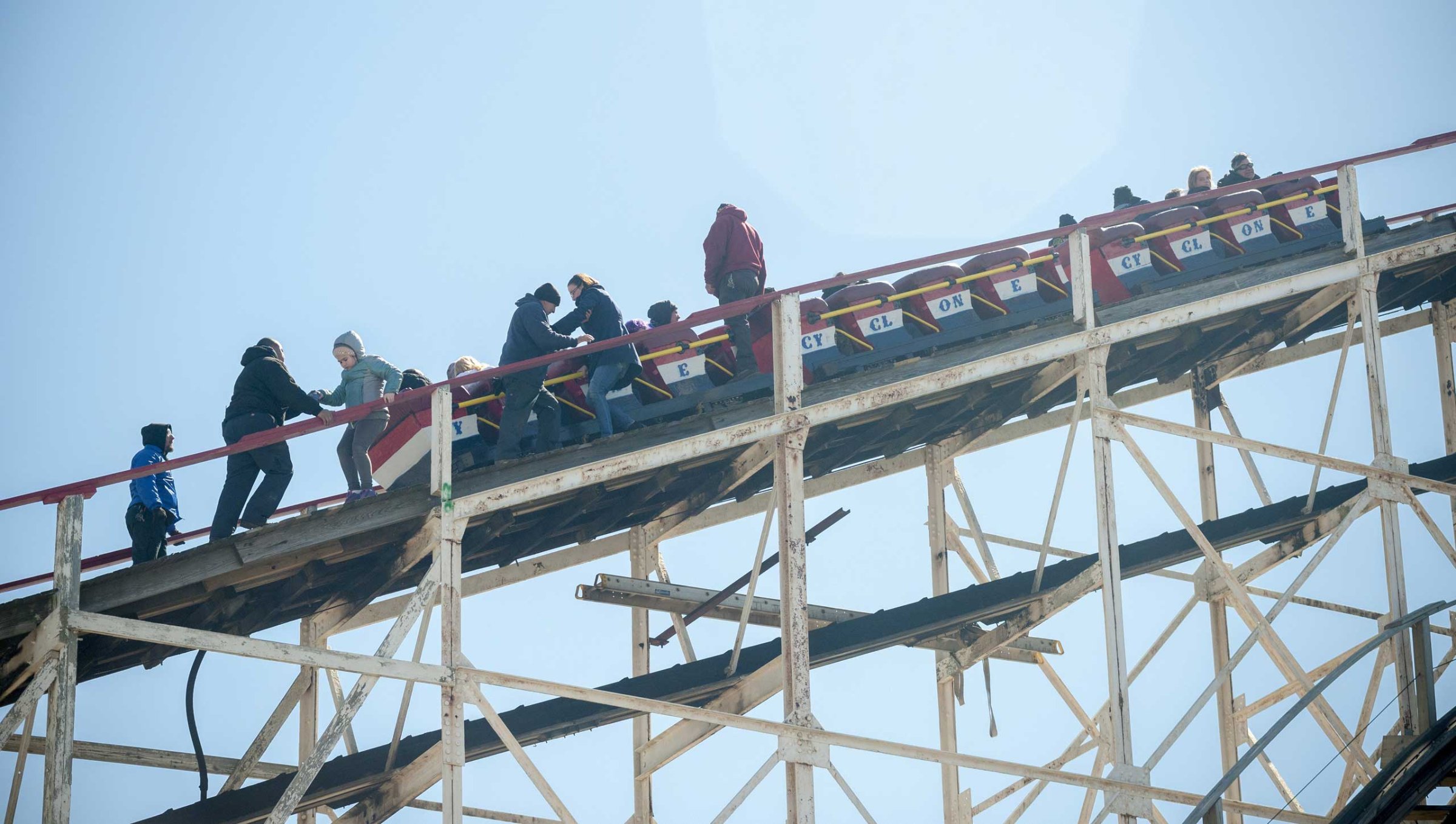 Workers assist thrill seekers on the Luna Park Coney Island Cyclone roller coaster after it got stuck on its inaugural run of the Summer 2015 season, on March 29, 2015 in Brooklyn, N.Y.