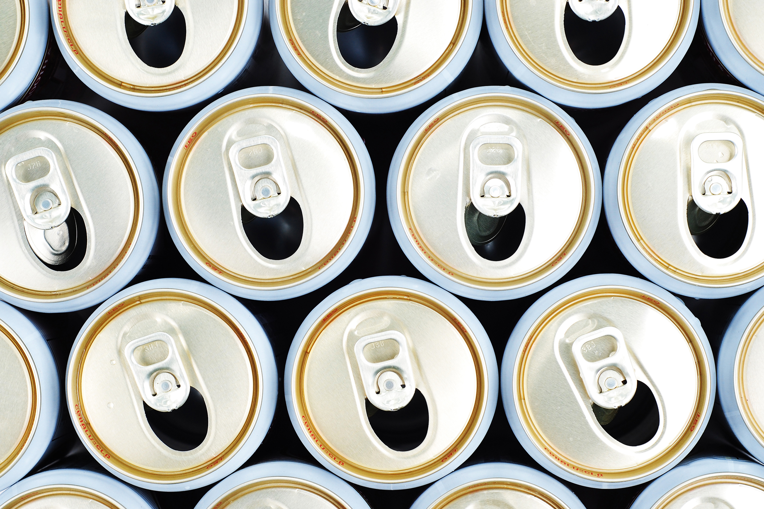 row of opened beer cans, top view