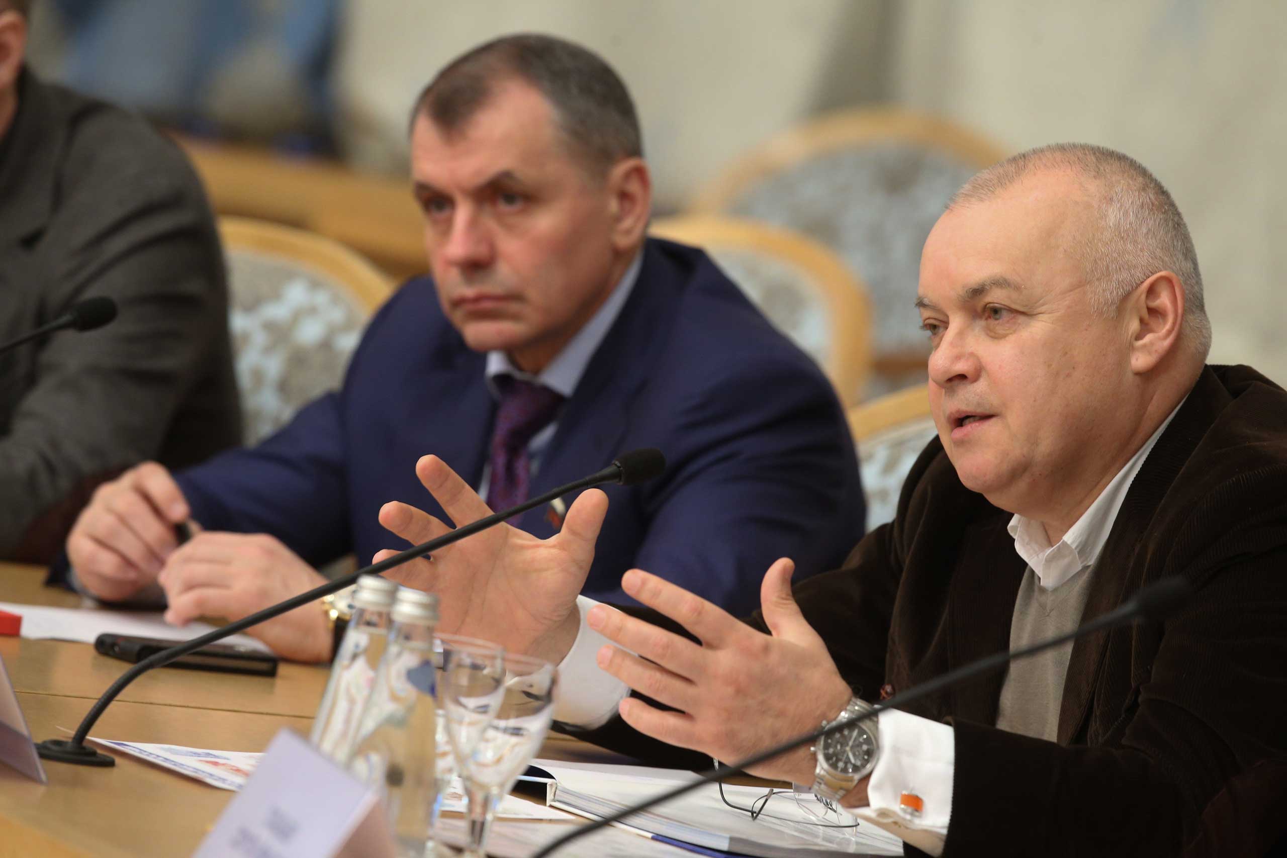 Dmitri Kiselyov, who runs the Kremlin’s media conglomerate, Rossiya Segodnya, attends a round table discussion dedicated to the first anniversary of the reunification of Crimea with the Russian Federation at Moscow's President Hotel, March 19, 2015. (Vyacheslav Prokofyev—Itar-Tass/Corbis)