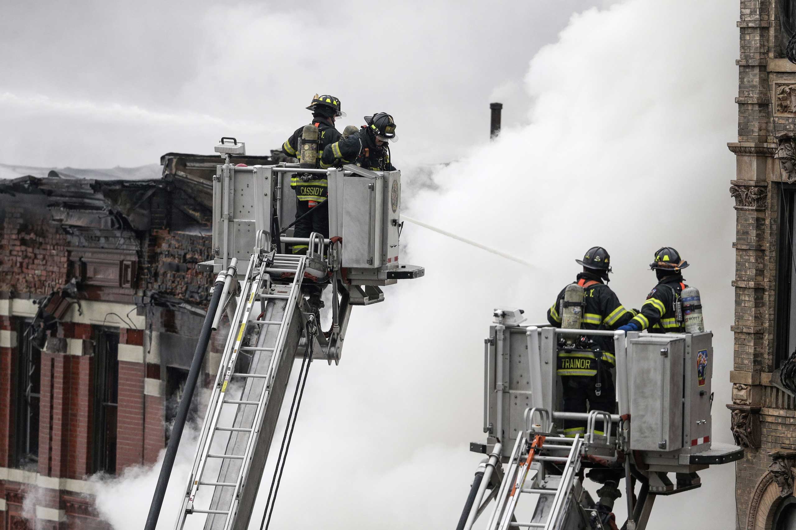 New York City Fire Department firefighters battle a fire in the East Village neighborhood of New York City on March 26, 2015.