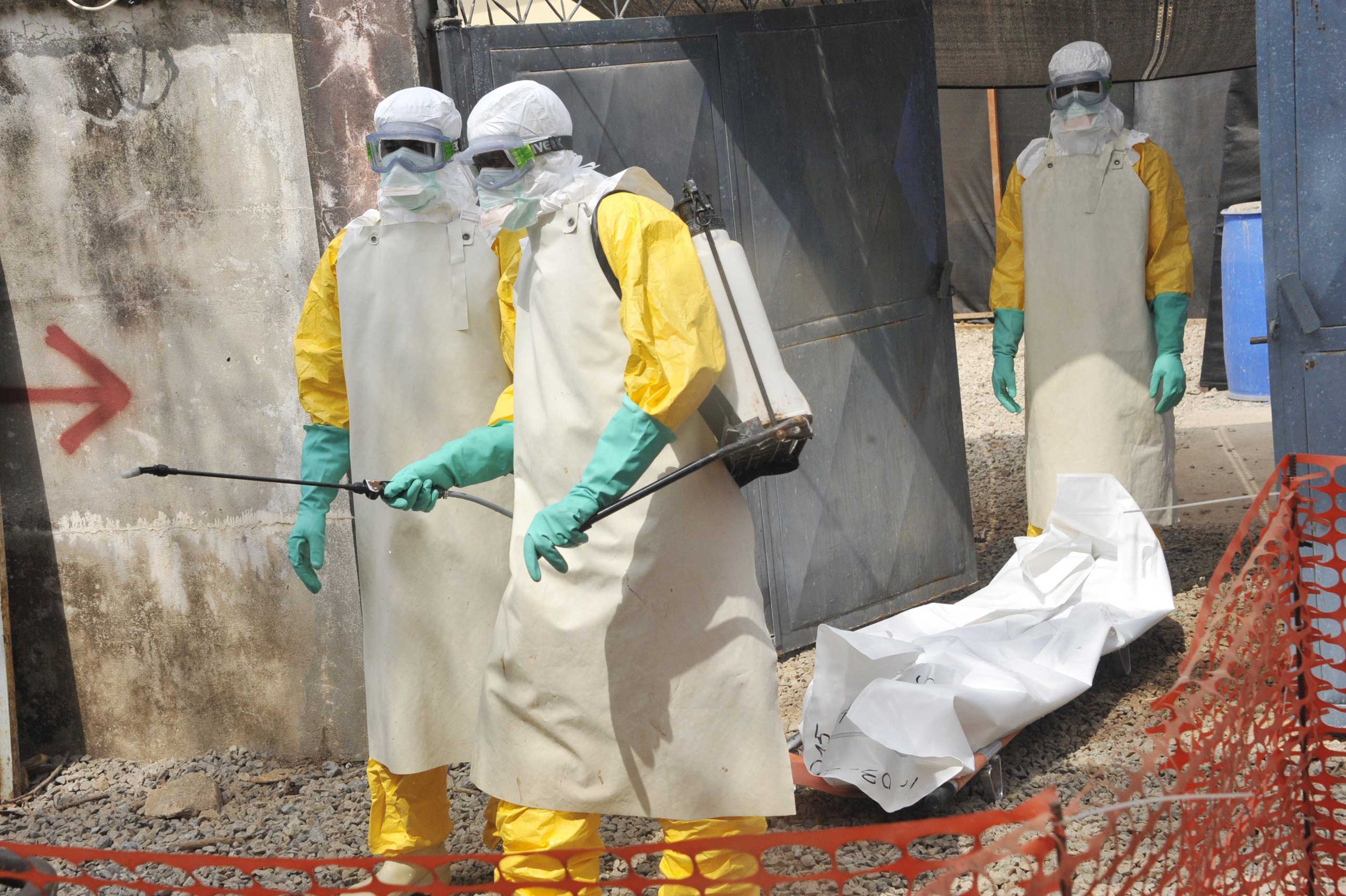 Members of the Guinean Red Cross move the body of a person who died from the Ebola virus on March 8, 2015 at the Donka hospital in Conakry. (Cellou Binani—AFP/Getty Images)