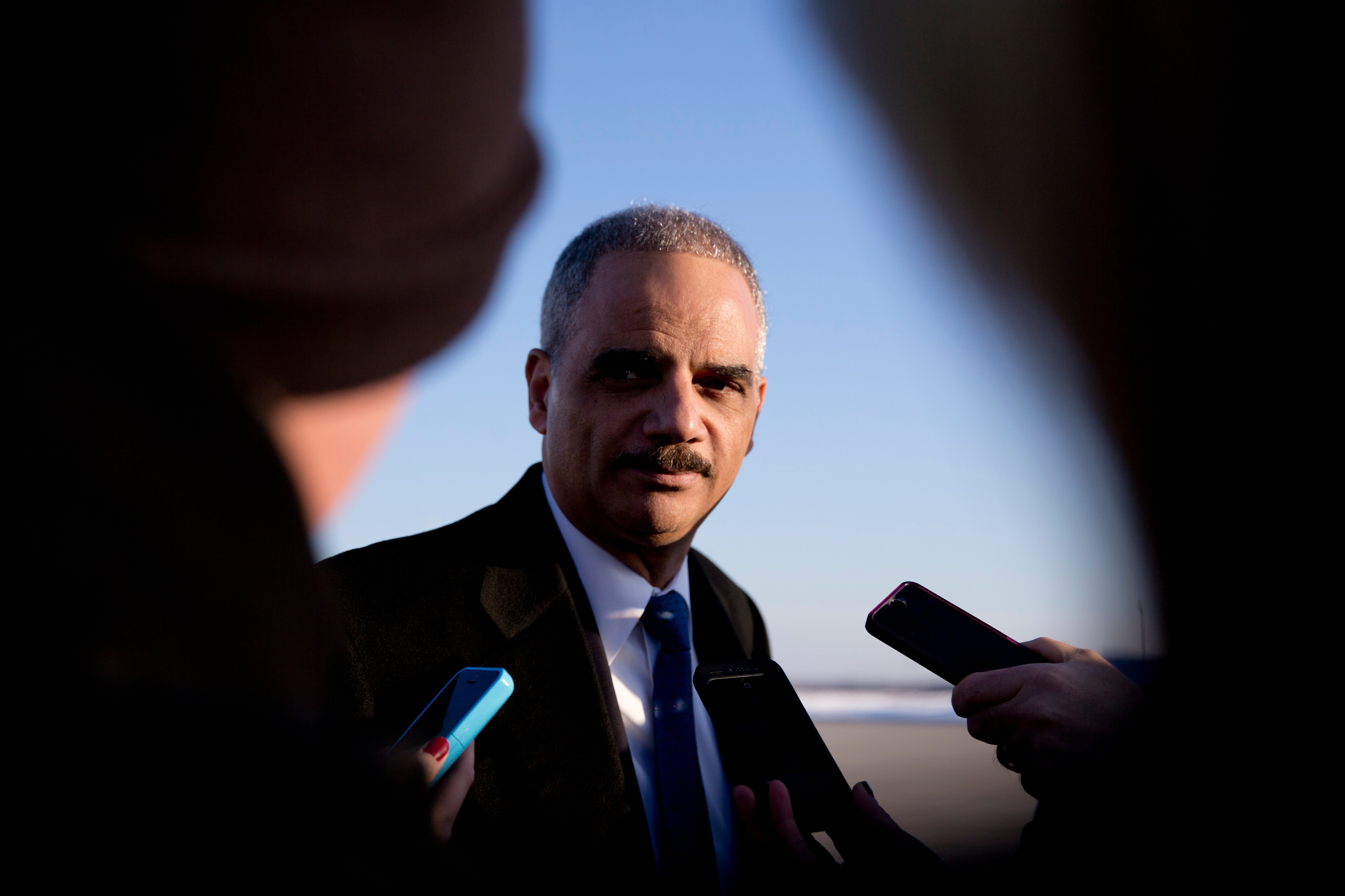Attorney General Eric Holder talks with media as he arrives on Air Force One in Andrews Air Force Base, Md. on March 6, 2015, with President Barack Obama, from Columbia, S.C. (Carolyn Kaster—AP)