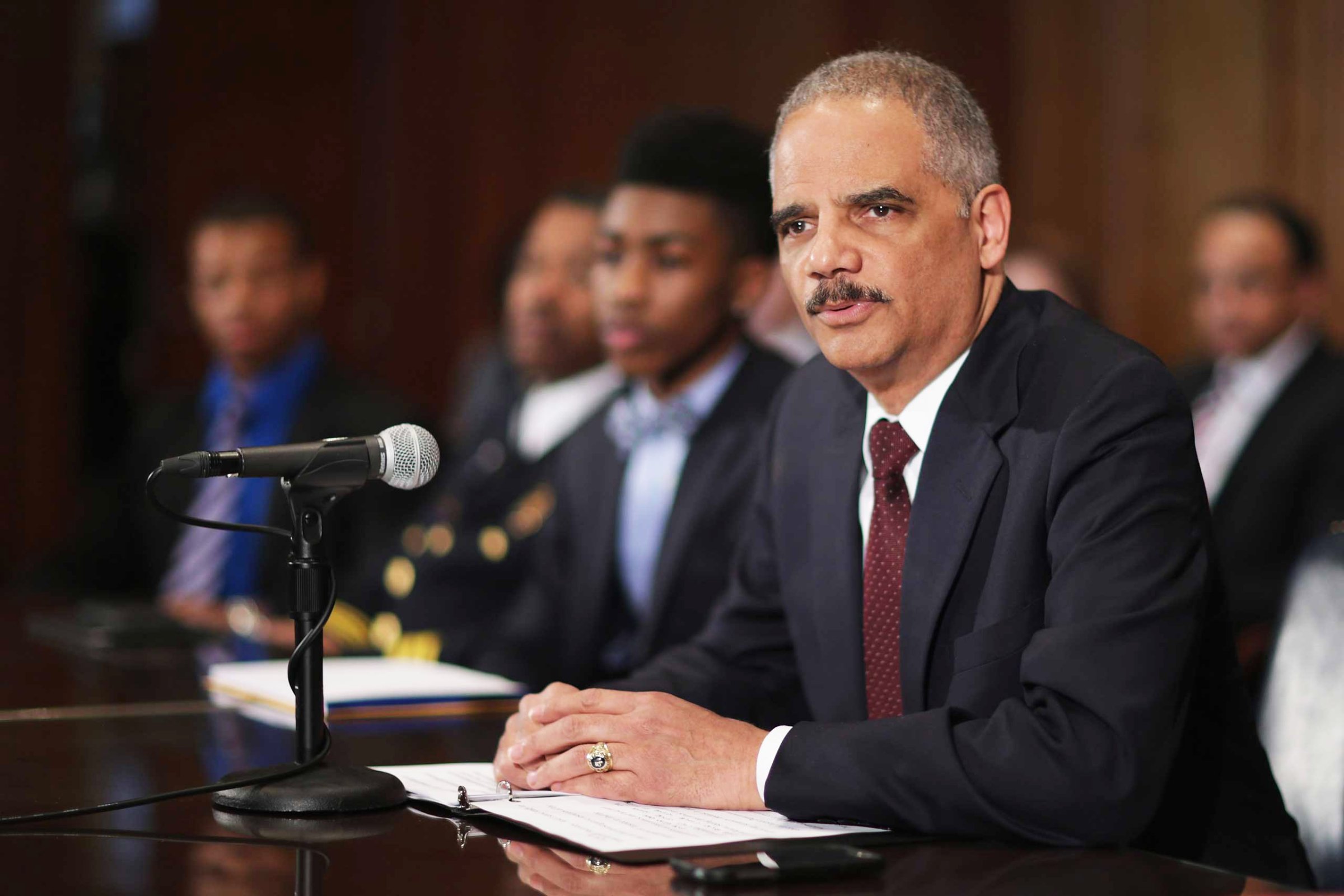 U.S. Attorney General Eric Holder delivers remarks about the shooting of two police officers in Ferguson, Missouri, while announcing the first six pilot sites for the National Initiative for Building Community Trust and Justice at the Department of Justice March 12, 2015 in Washington, DC.