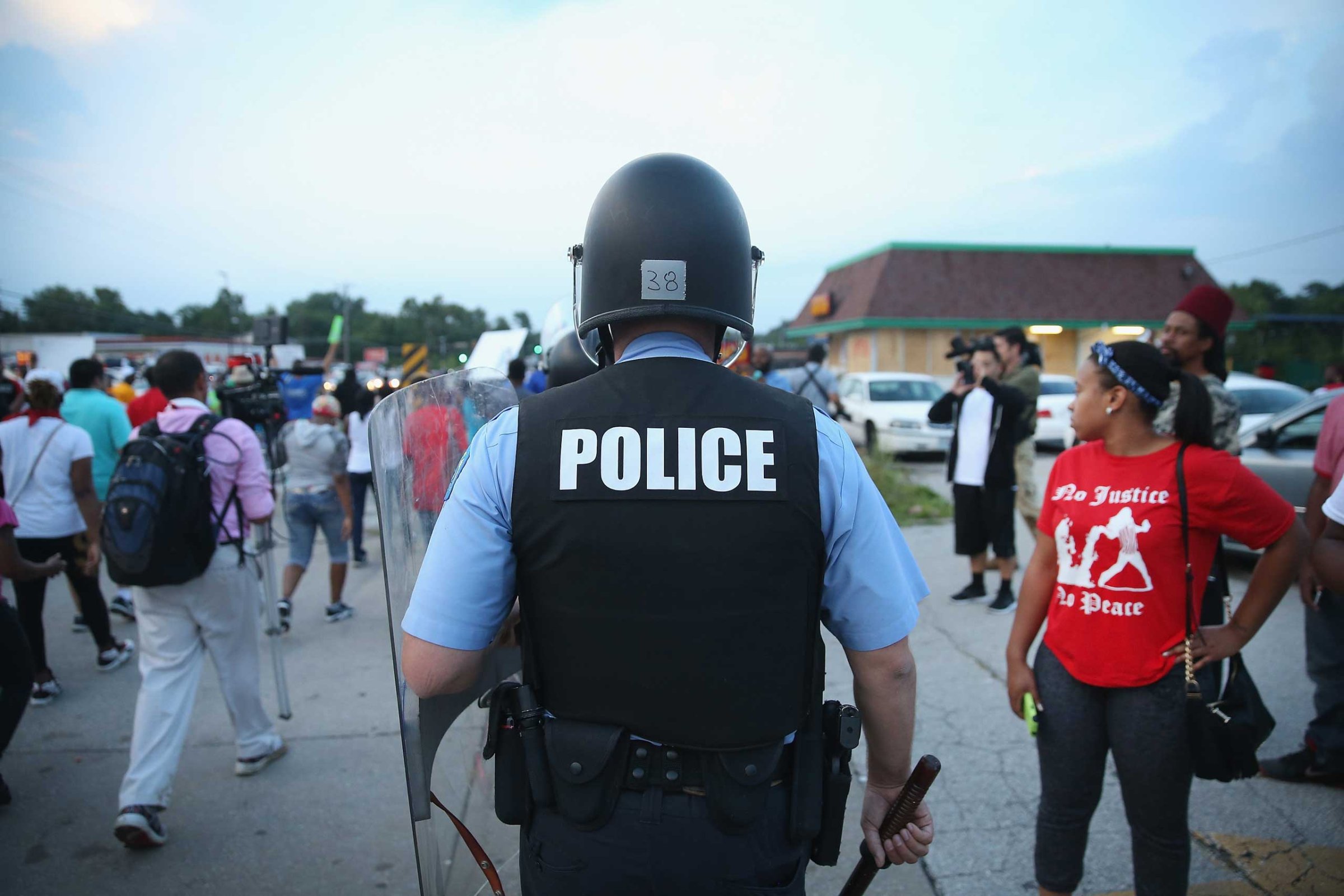 Police are deployed to keep peace along Florissant Avenue in Ferguson, Mo. on Aug. 16, 2014.