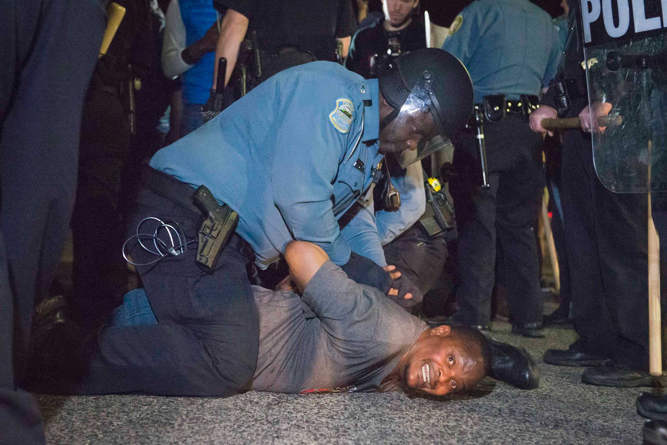 Police arrests a protestor outside the City of Ferguson Police Department and Municipal Court in Ferguson, March 11, 2015.