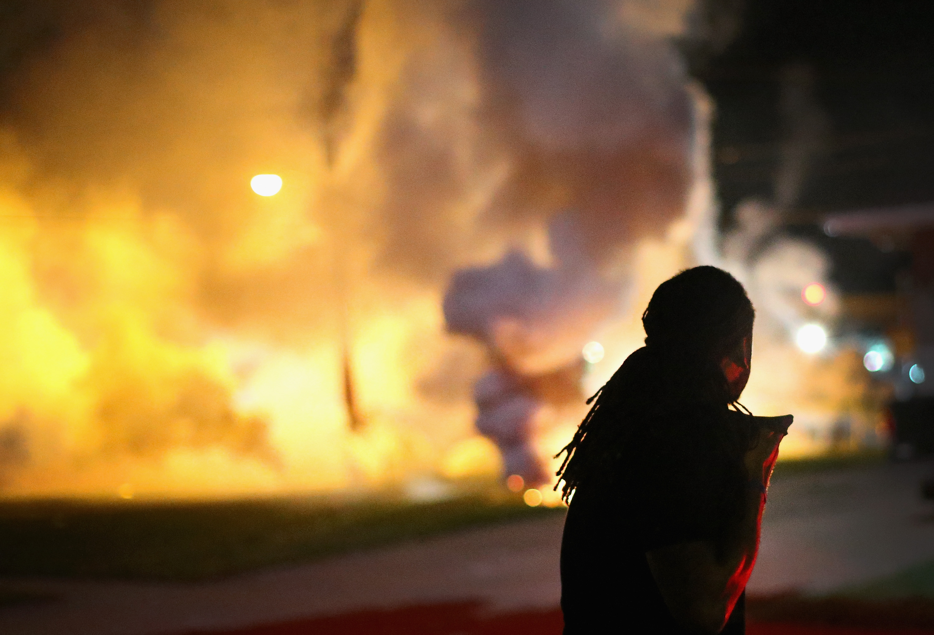 A demonstrator, protesting the shooting death of teenager Michael Brown, scrambles for cover as police fire tear gas on August 13, 2014 in Ferguson, Missouri. (Scott Olson&mdash;Getty Images)