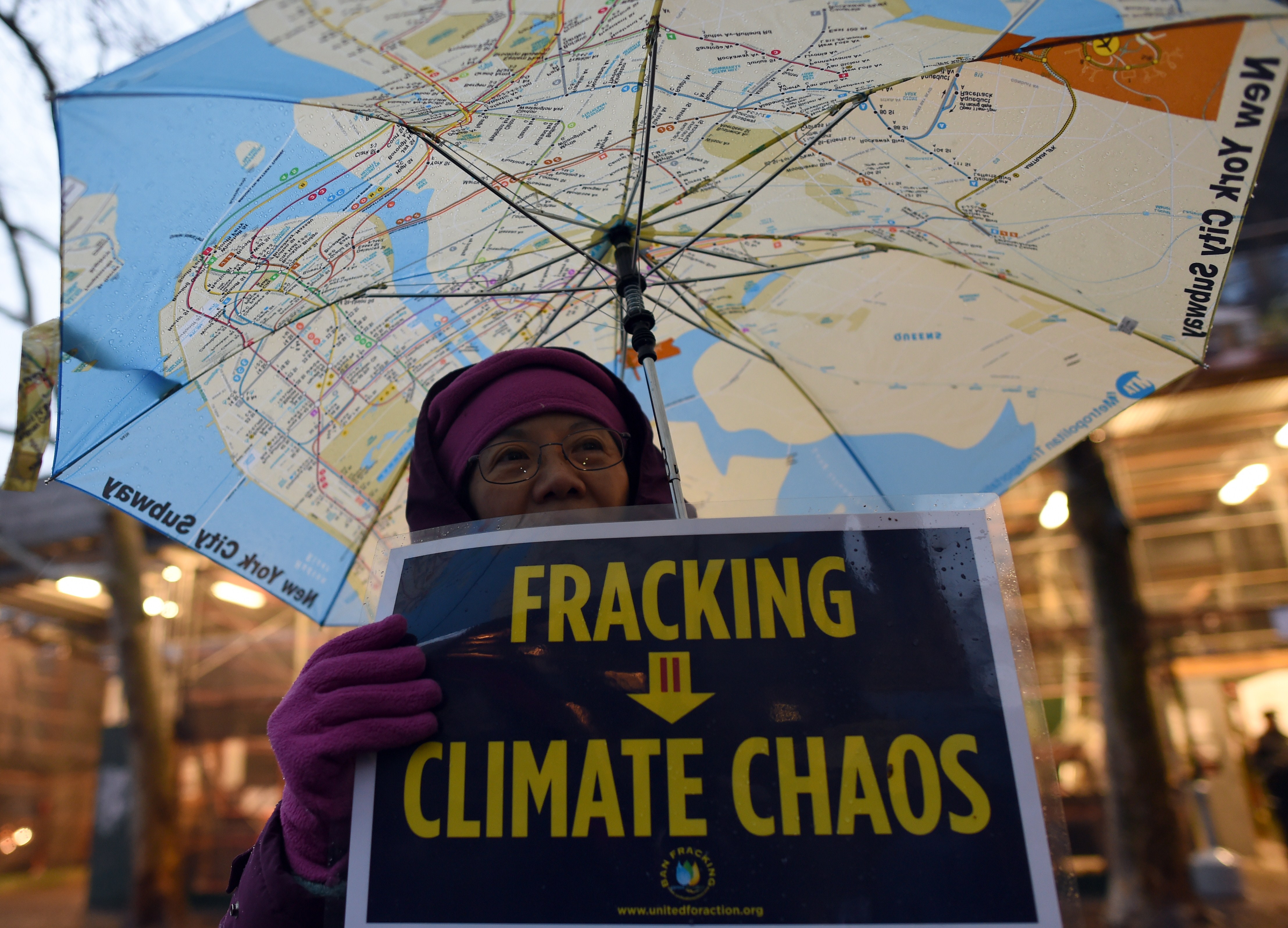 A woman holds an anti-fracking sign as a group of demonstrators gather for a rally for a Global Climate Treaty on Dec. 10, 2014 in New York City.
