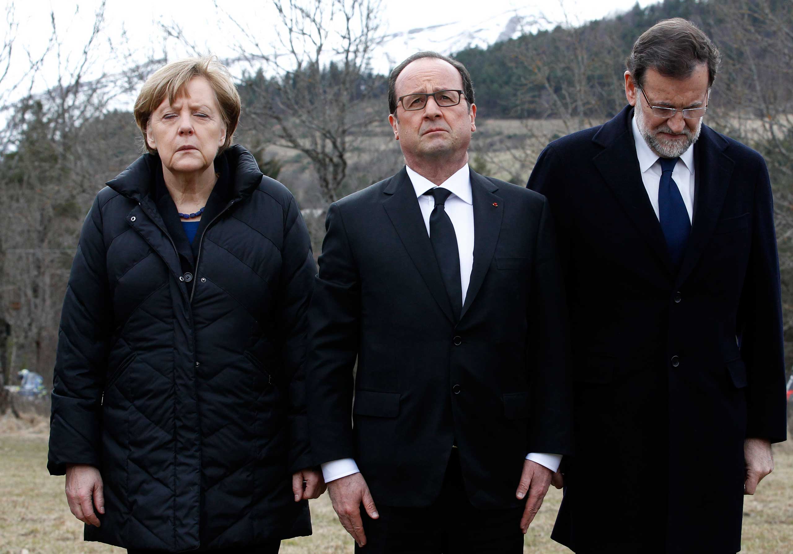 German Chancellor Angela Merkel, French President Francois Hollande, and Spanish Prime Minister Mariano Rajoy pay respect to victims in front of the mountain where a Germanwings jetliner crashed in Le Vernet, France, March 25, 2015.